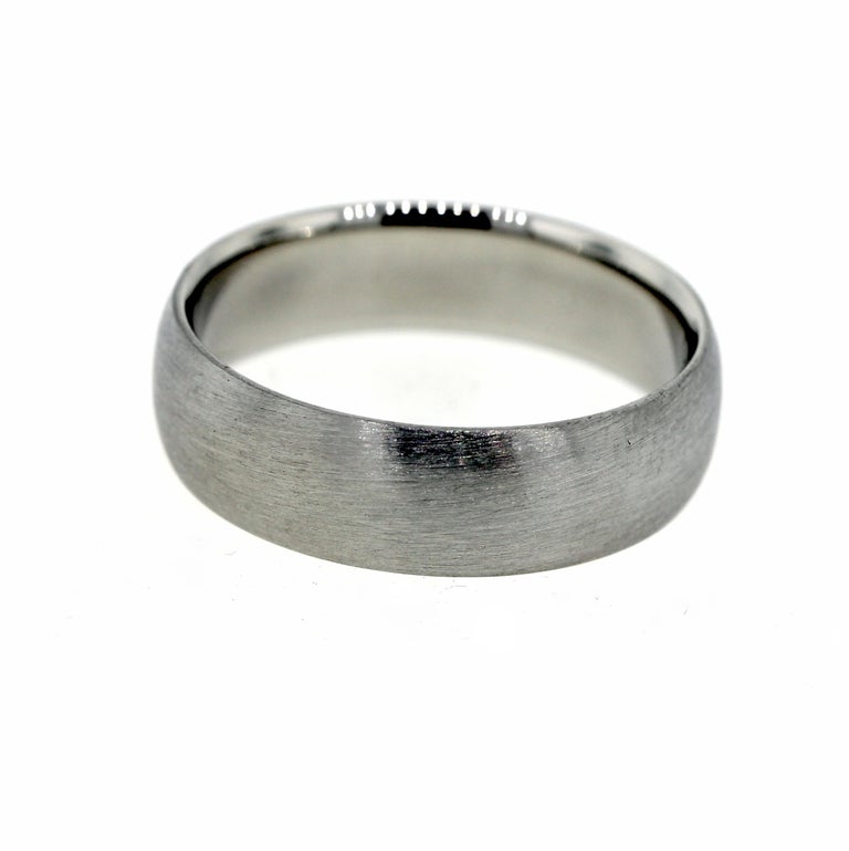 This men’s wedding band is made with platinum and has a dark charcoal color. It is 5MM wide. 

