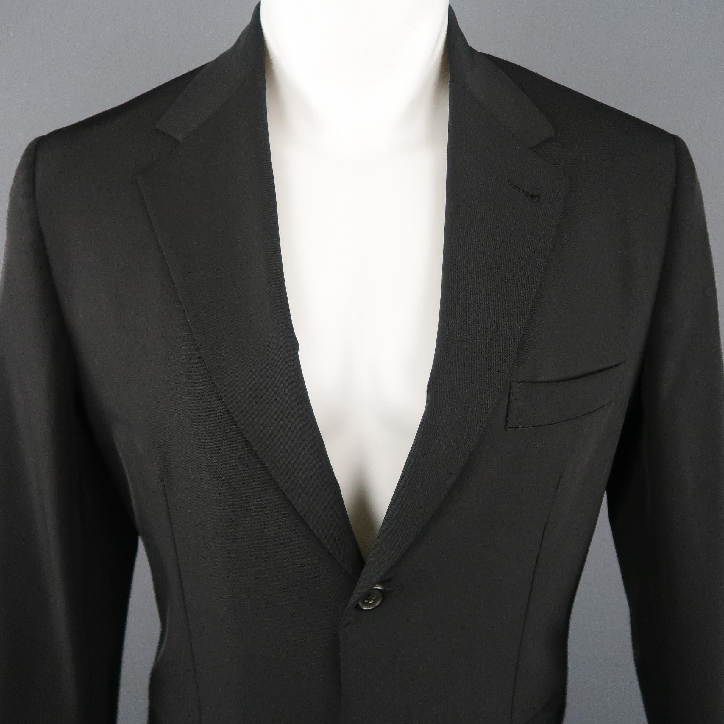 PRADA Sport Coat comes in a black tone in a polyester blend material, with a notch lapel, slit pockets, 2 buttons at closure, single breasted, buttoned cuffs and a single vent at back. Minor wear.  Made in Italy.
 
Very Good Pre-Owned