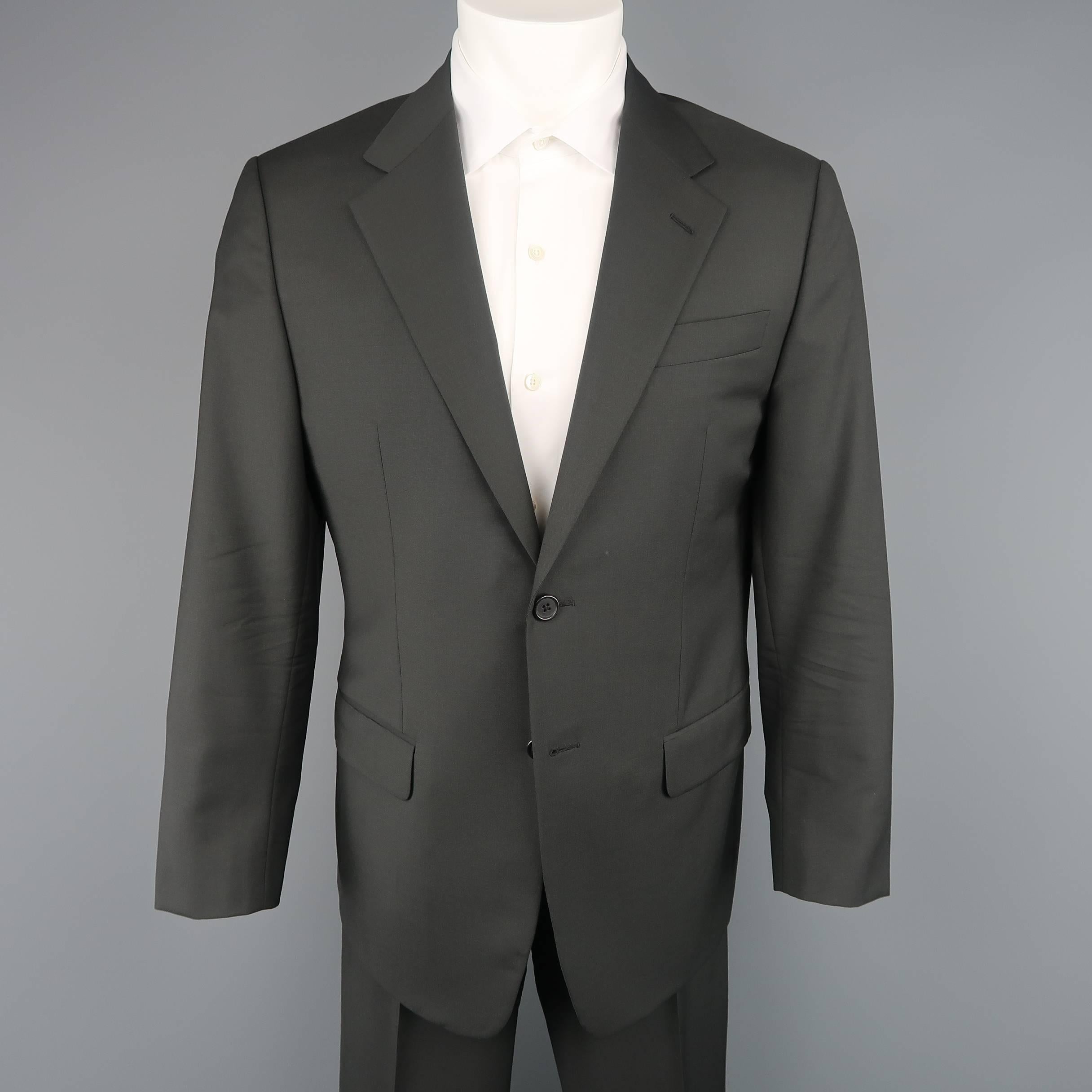 Two piece suit by PRADA comes in dark gray wool mohair blend fabric and includes a single breasted two button sport coat with notch lapel and matching flat front trousers with side tabs.  Made in Italy.
 
Excellent Pre-Owned Condition.
Marked: IT 50