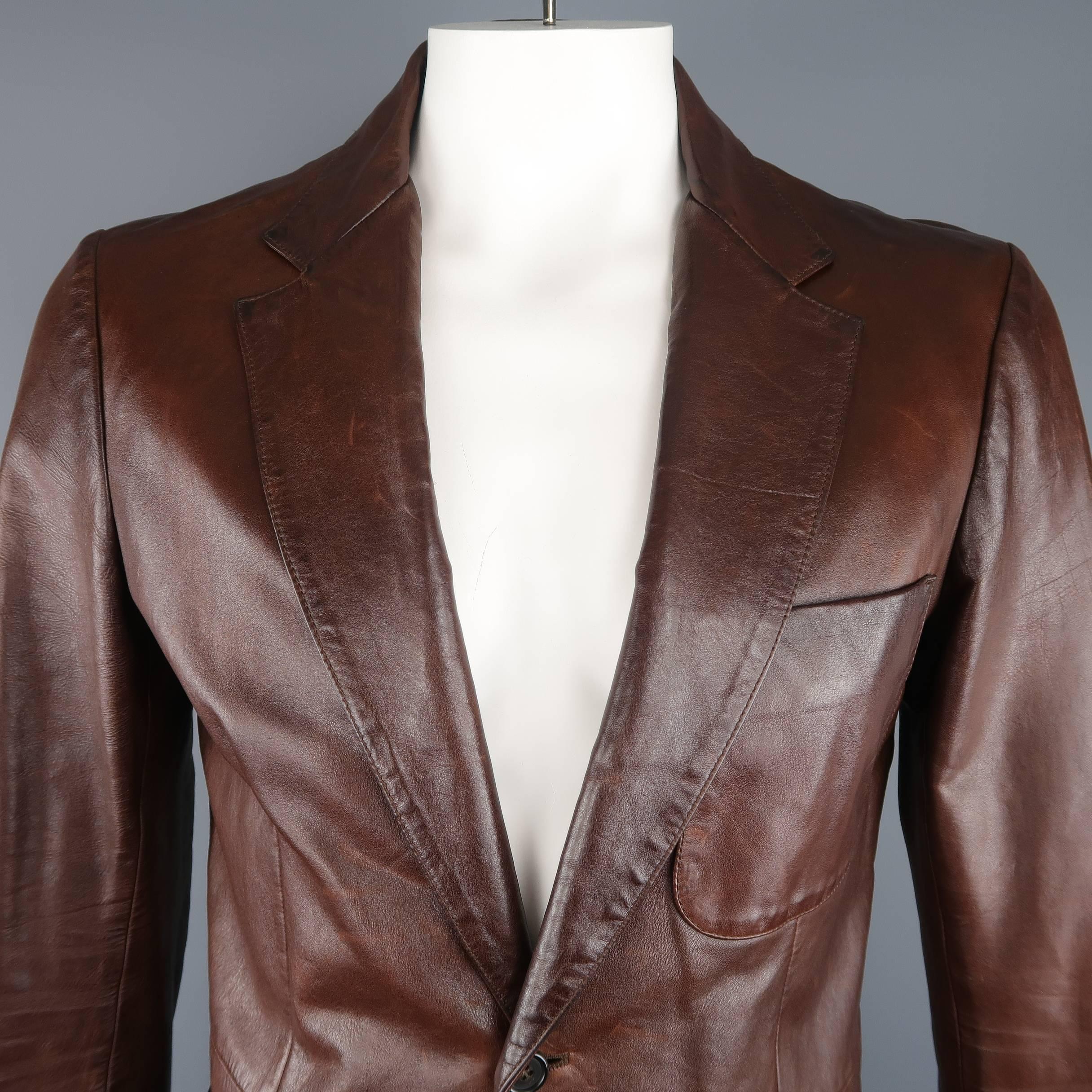Vintage PRADA sport coat comes in brown leather with a notch lapel, two button front, functional button cuffs, and patch pockets. Wear throughout leather and mark on front. As-is. Made in Italy.
 
Fair Pre-Owned Condition.
Marked: IT 52
