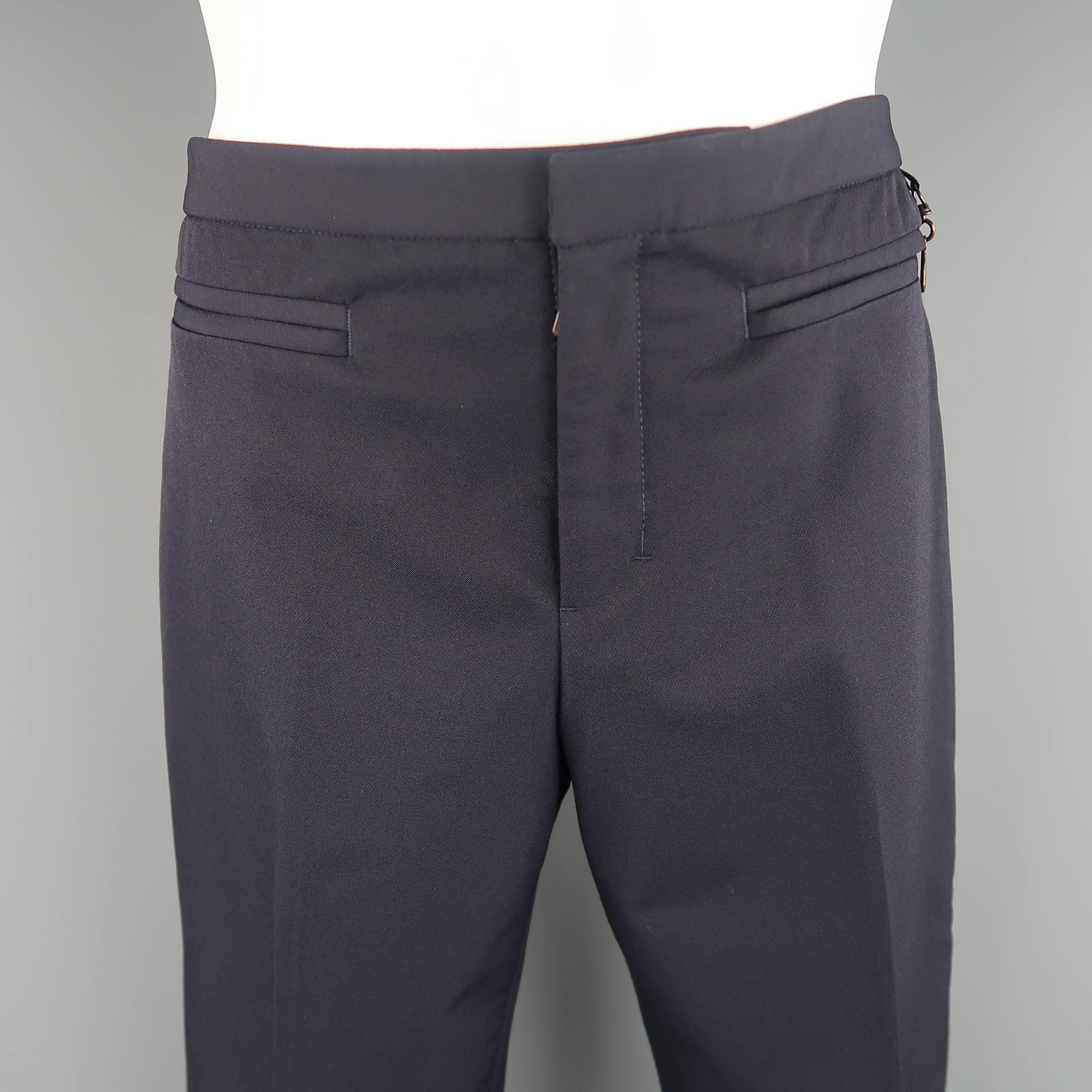 PRADA pants come in dark navy blue stretch nylon with a flat front, velcro frontal pockets, key loop, and back zip pockets. No tags and wear on hardware. Made in Italy.
 
Good Pre-Owned Condition.
Marked: (no size)
 
Measurements:
 
Waist: 32 in.