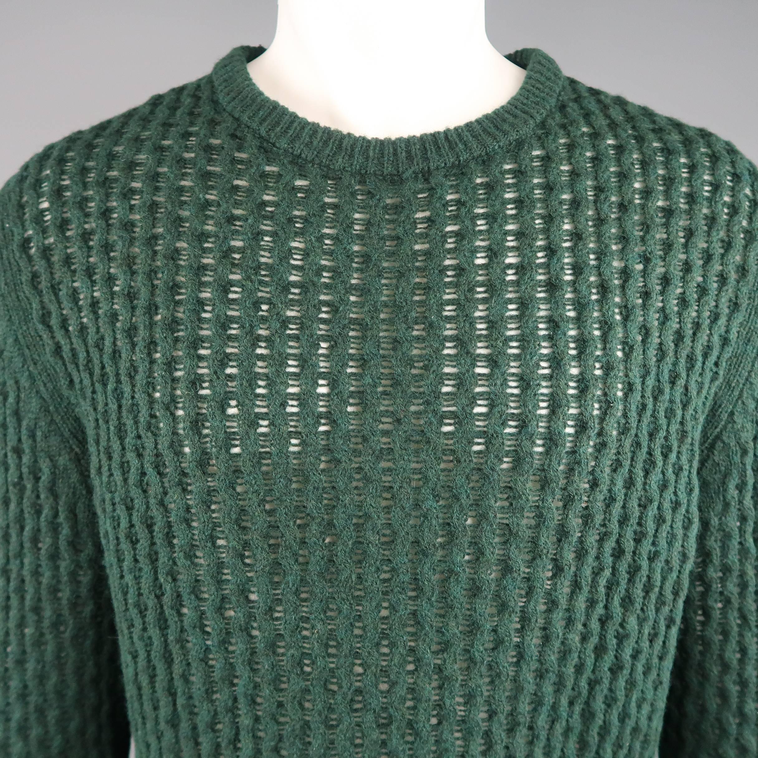 RAF SIMONS pullover sweater comes in a forest green merino wool mesh knit with a rubbed crewneck. Made in Italy.
 
Excellent Pre-Owned Condition.
Marked: M
 
Measurements:
 
Shoulder: 19 in.
Chest: 48 in.
Sleeve: 31 in.
Length: 29 in.
