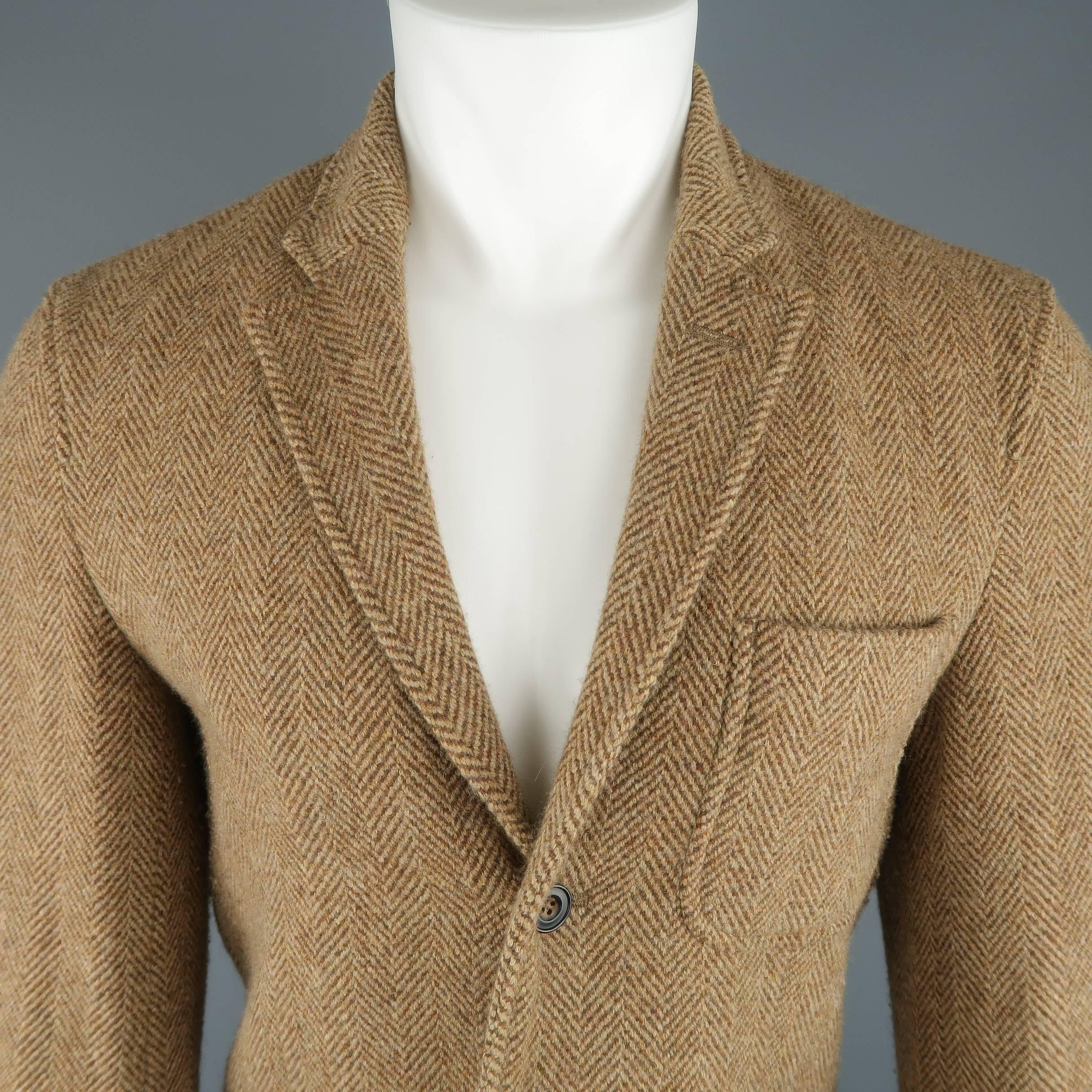 POLO RALPH LAUREN sport coat comes in tan Herringbone wool with a notch lapel, three button front, and patch flap pockets.
 
Good Pre-Owned Condition.
Marked: 38 R
 
Measurements:
 
Shoulder: 17 in.
Chest: 40 in.
Sleeve: 26 in.
Length: 30 in.
