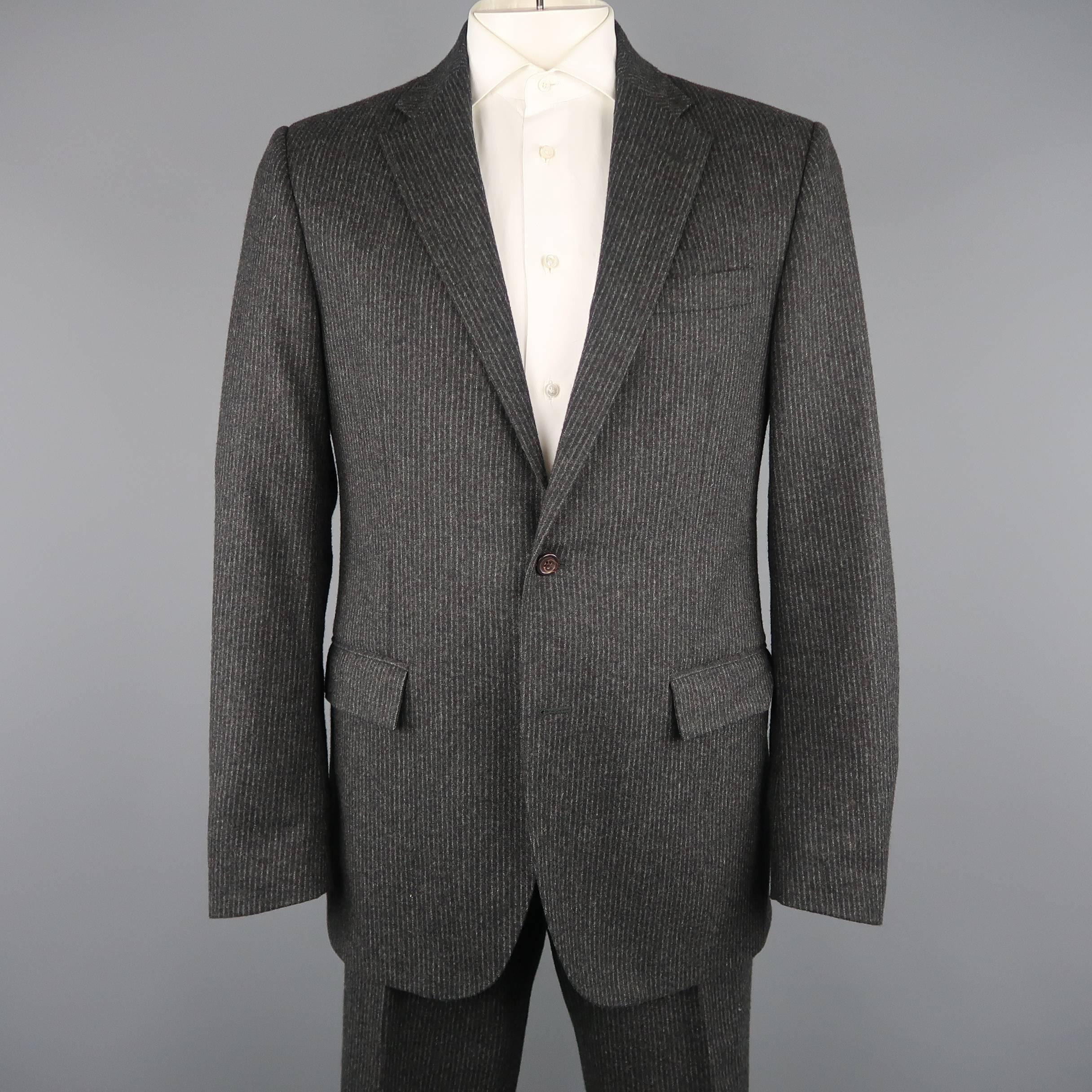 Polo Ralph Lauren suit comes in a charcoal pinstripe wool cashmere felt and includes a single breasted, two button, notch lapel sport coat with matching cuffed hem trousers. Made in Italy.
 
Excellent Pre-Owned Condition.
Marked: 42
 
Measurements:
