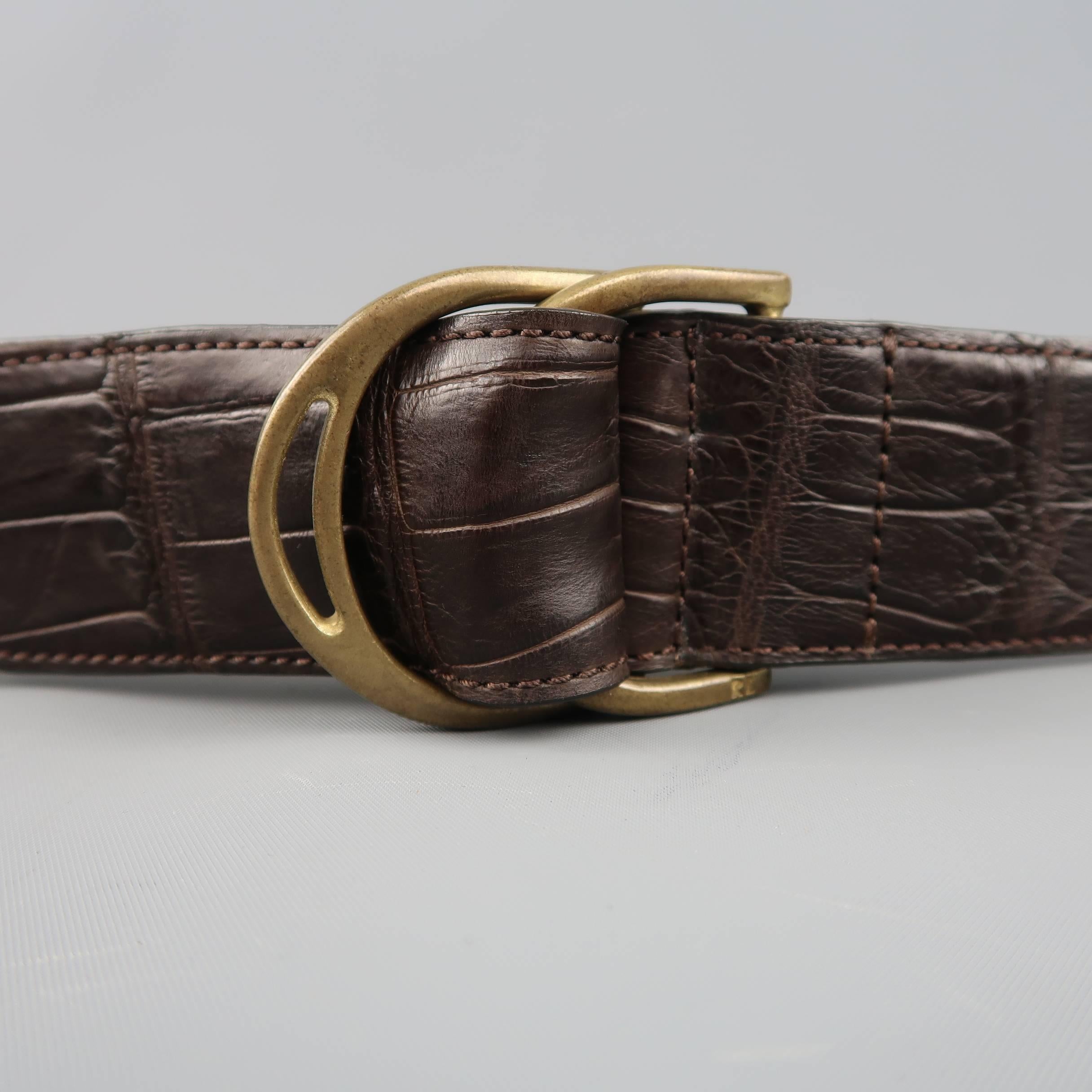 RALPH LAUREN belt comes in brown alligator leather with tan leather liner and double gold tone D ring loop closure. Made in Italy.
 
Excellent Pre-Owned Condition.
Marked: S
 
Measurements:
 
Length: 39 in.
Width: 1.5 in.
Fits: 32 in.

