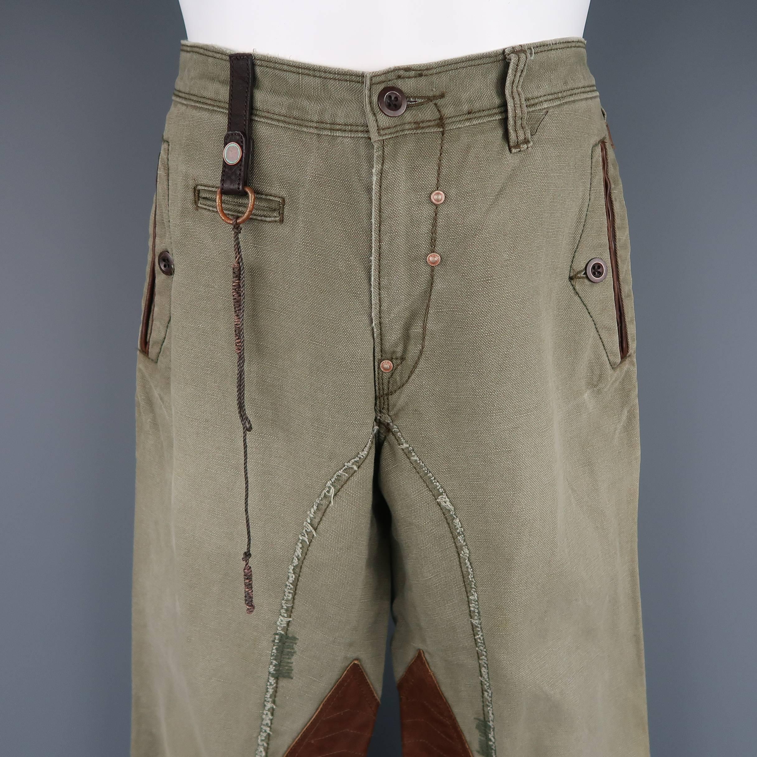 POLO RALPH LAUREN utility style pants come in washed olive green canvas with leather trimmed slot pockets, grommet detailed fly, leather loop with rope embellishment, quilted tan leather inner leg panels, and belt tab detailed legs. Small mark on