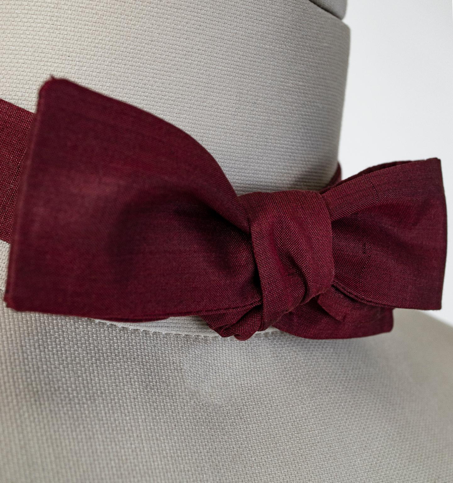 A gentleman in a bow tie is rare enough, but a man who can tie one from scratch is a unicorn. If you are that man, why not go one step further and opt for a vintage model? This one in iridescent burgundy silk features a slim profile and square ends,