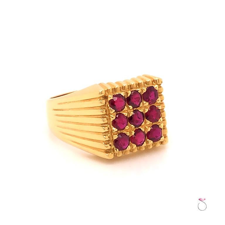 Beautiful men's Ruby ring in 18K yellow gold. This ring features 9 round red Rubies each set 4 prongs in a square arrangement. The Rubies have a vibrant red color. The total weight of Rubies is approximately 1.35 carat. The ring has a unique fluted