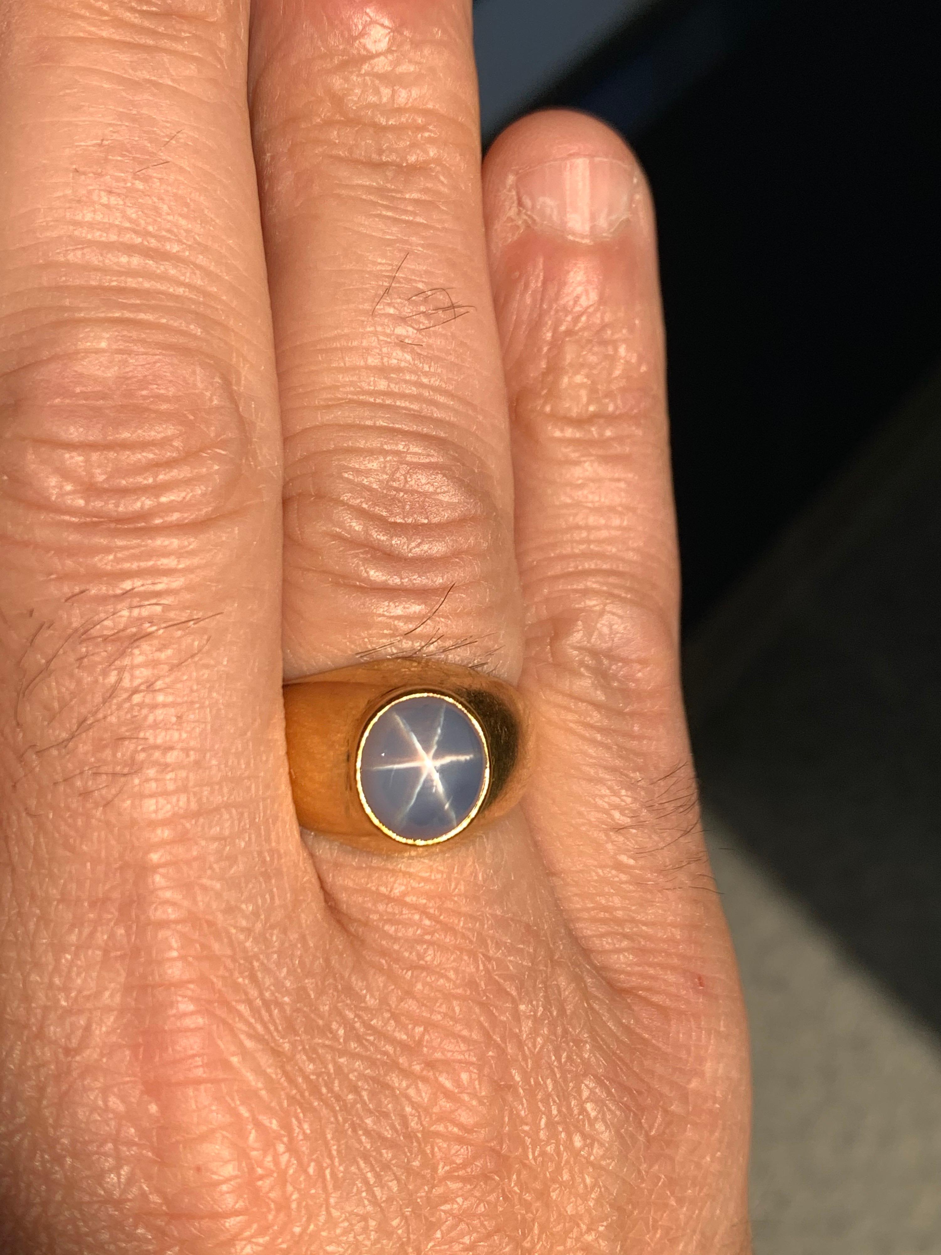 Men’s Retro 18k Yellow Gold Ring. Natural 10 Carat (approximate) Cabochon Bluish Star Sapphire measuring 11.1x10x8.6mm.

The star most visible outdoors in daylight, an accurate image of indoor lighting with star not visible is provided. 

The ring