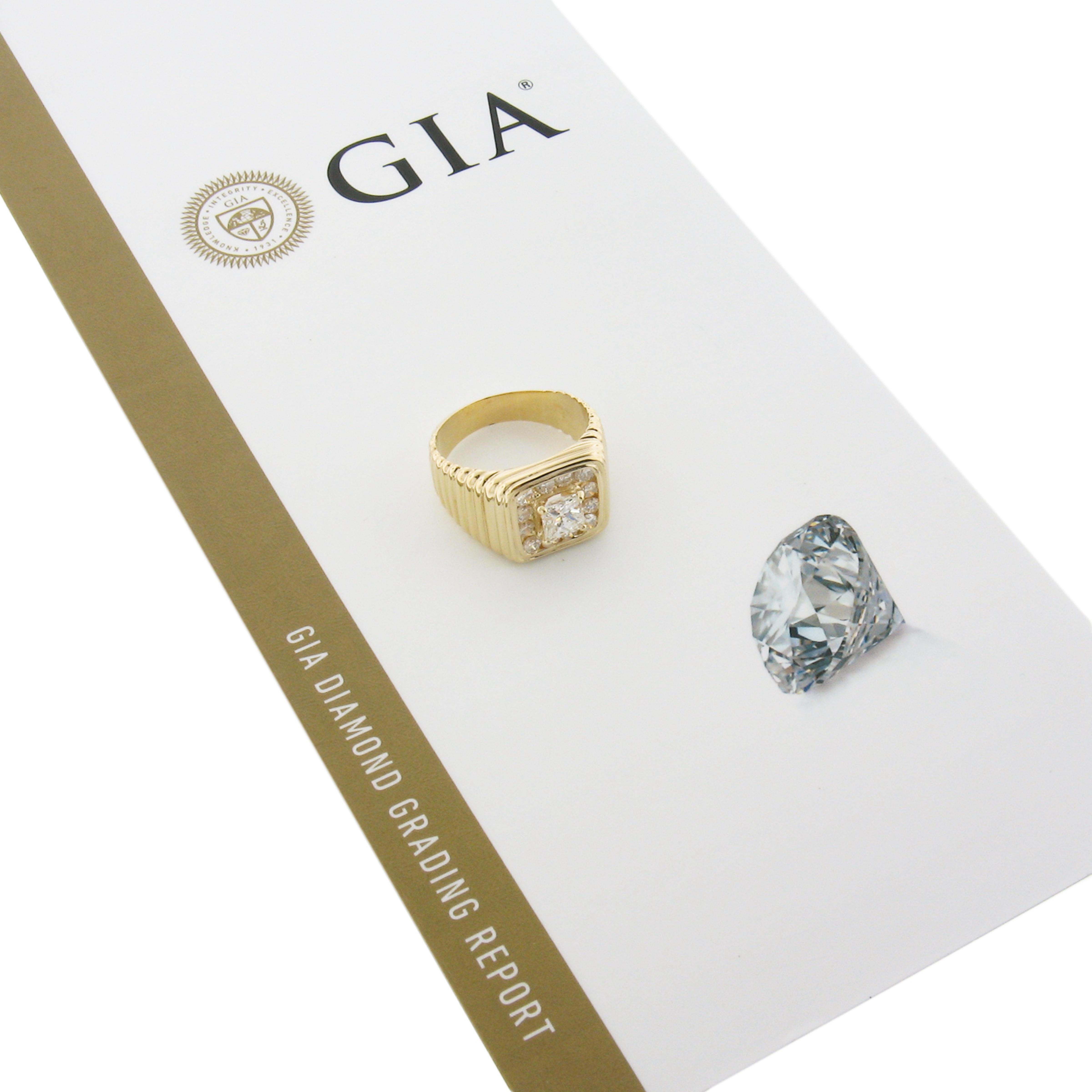 This bold men's ring is crafted in solid 14k yellow gold featuring a ribbed & grooved design and is set with a fine quality, GIA certified fiery princess cut diamond. The solitaire stone is adorned with a halo of 12 round brilliant cut channel set