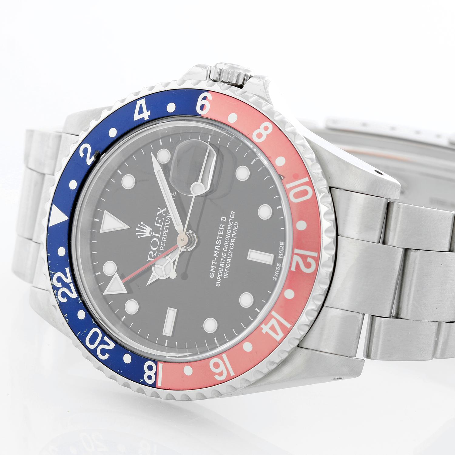 Men's Rolex GMT-Master II Watch 16710 - Automatic winding, 31 jewels, Quickset, sapphire crystal. Stainless steel case; rotating bezel with black/red bezel (40mm diameter). Black dial with luminous style markers. Stainless steel Oyster bracelet.