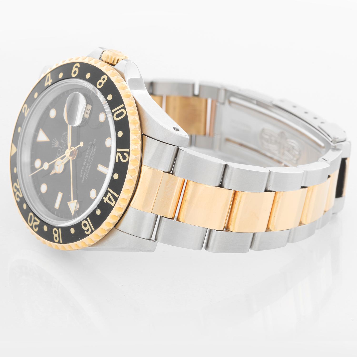Men's Rolex GMT-Master II Watch 16713 - Automatic winding, 31 jewels, Quickset, sapphire crystal. Stainless steel with 18k yellow gold bezel with black insert. Black dial with luminous style markers. Stainless steel & 18k yellow gold Oyster