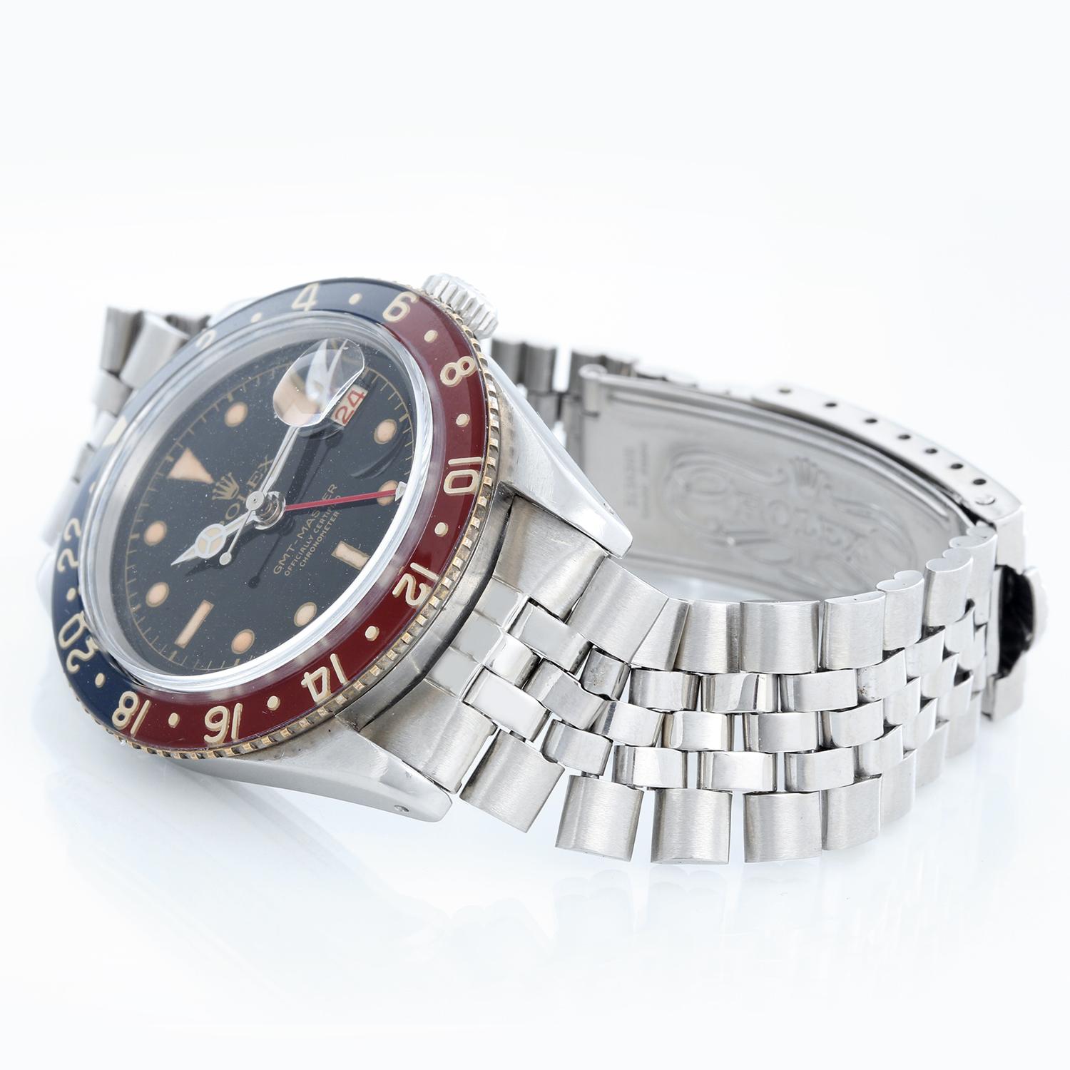 Men's Rolex GMT-Master Stainless Steel  Watch 6542 - Automatic winding, 31 jewels. Stainless steel case with blue and red rotating bezel (40 mm). Black dial with luminous markers. Stainless steel Rolex Jubilee bracelet. Pre-owned with Rolex box.