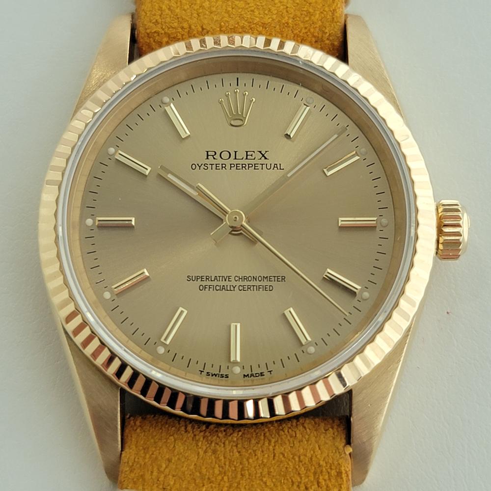 Rare luxurious classic, Men's 18k solid gold Rolex Oyster Perpetual Ref.14238 automatic, c.1991, in excellent working condition. Verified authentic by a master watchmaker. Gorgeous Rolex signed gold dial, applied baton indice hour markers, gilt