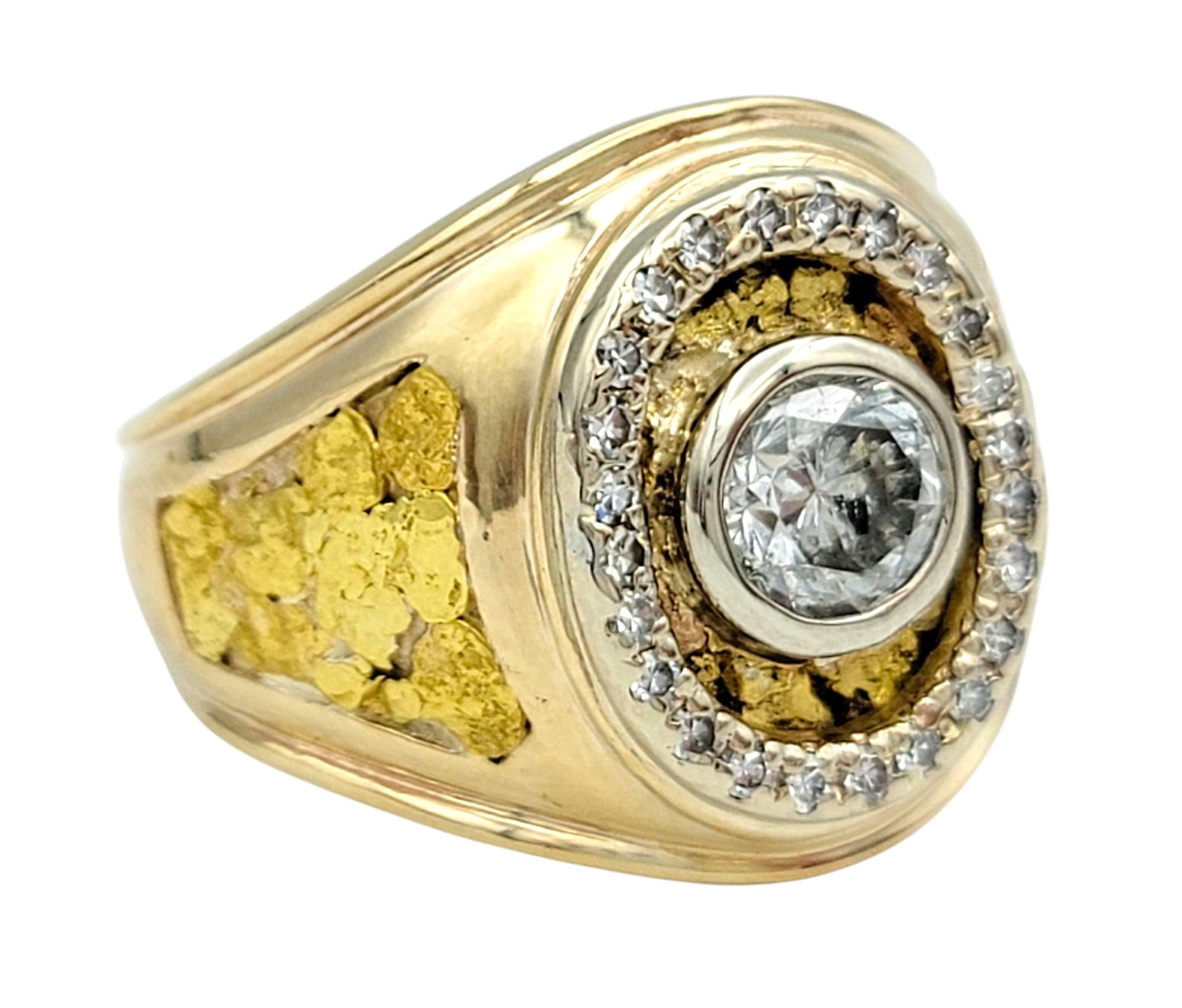 Ring Size: 11

This striking diamond ring showcases a brilliant round-cut center stone set in a bold two-tone gold design. The bezel set diamond is framed by a halo of glittering accent diamonds that extend along the shoulders, adding layers of