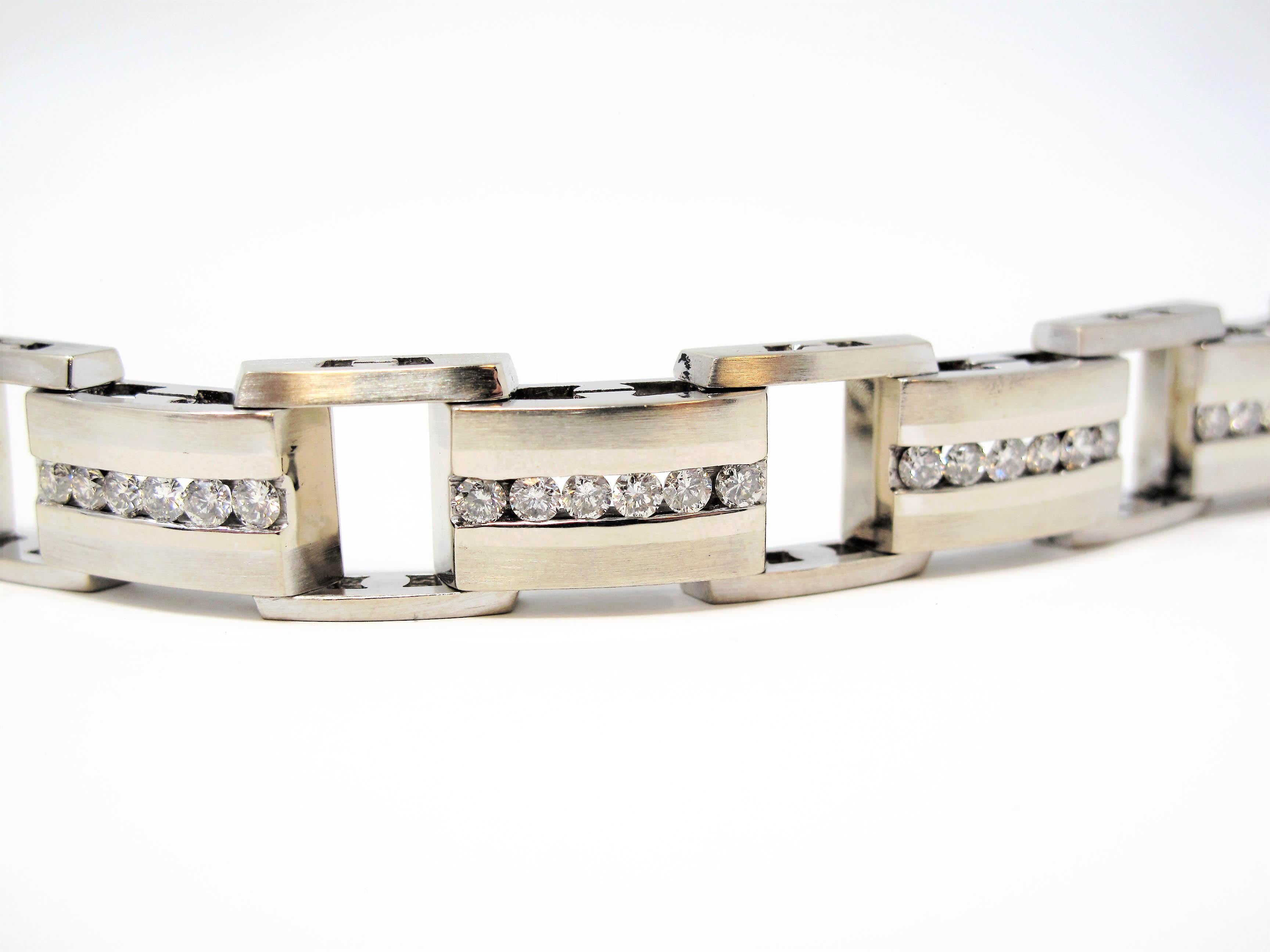 This striking mens diamond and 14 karat white gold link bracelet looks elegantly handsome on the wrist. The sleek, contemporary design of this stunning piece paired with the brilliant white diamonds, really draws the viewers attention, making this a