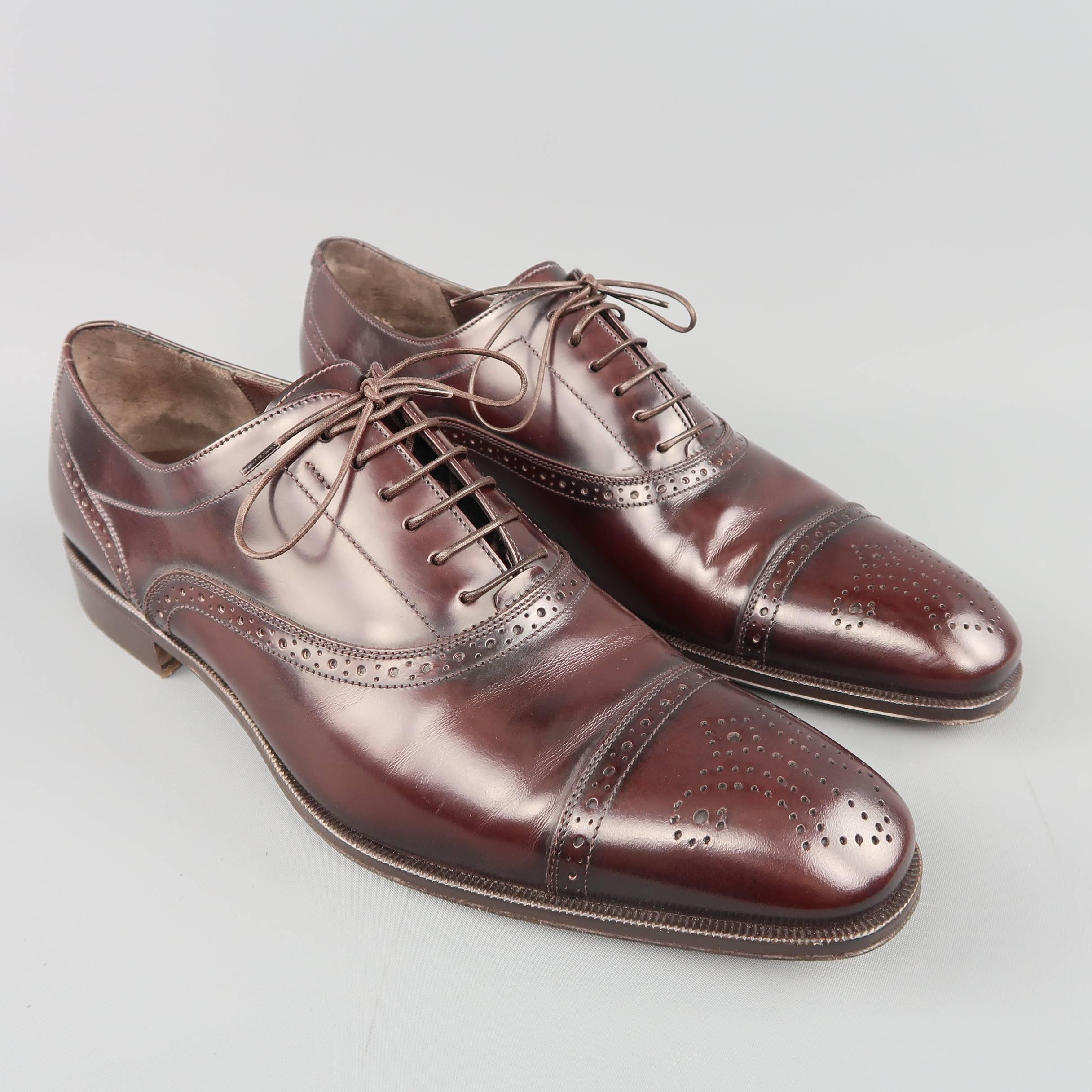 SALVATORE FERRAGAMO dress shoes come in burgundy tone brown smooth leather with a pointed cap toe and brogue details throughout. Made in Italy.
 
Excellent Pre-Owned Condition.
Marked: UK 9.5 D
 
Outsole: 12 x 4 in.
