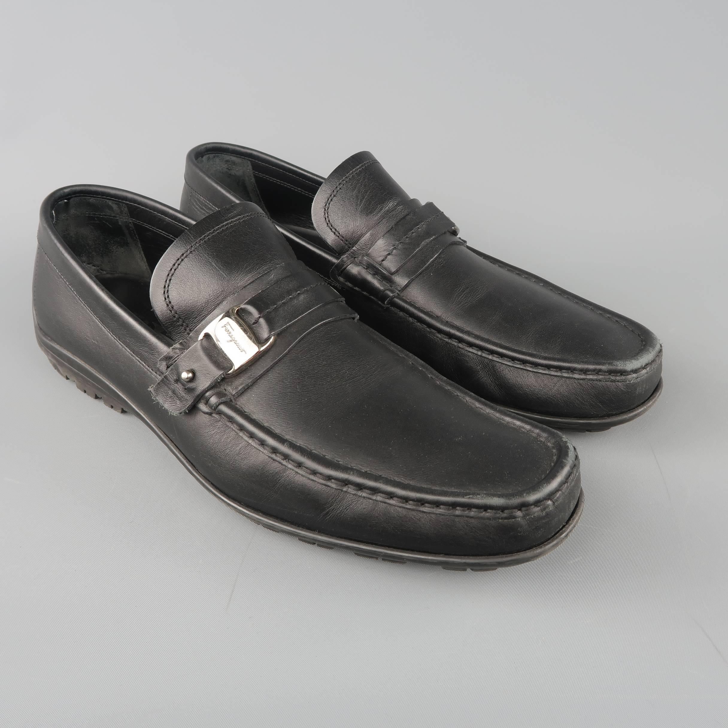SALVATORE FERRAGAMO loafers come in black leather with a squared point apron toe, driver sole, and strap with silver tone embossed detail. Made in Italy.
 
Good Pre-Owned Condition.
Marked: UK 10
 
Outsole: 12 x 4 in.