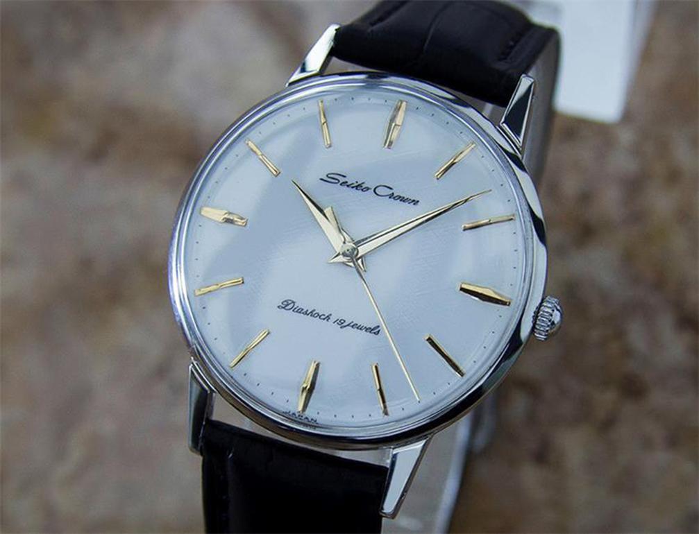 Time tested classic, Men's Seiko Crown manual wind dress watch, c.1950s. Verified authentic by a master watchmaker. Gorgeous Seiko signed polar silver dial, applied indice hour markers, gilt minute and hour hands, sweeping central second hand, hands