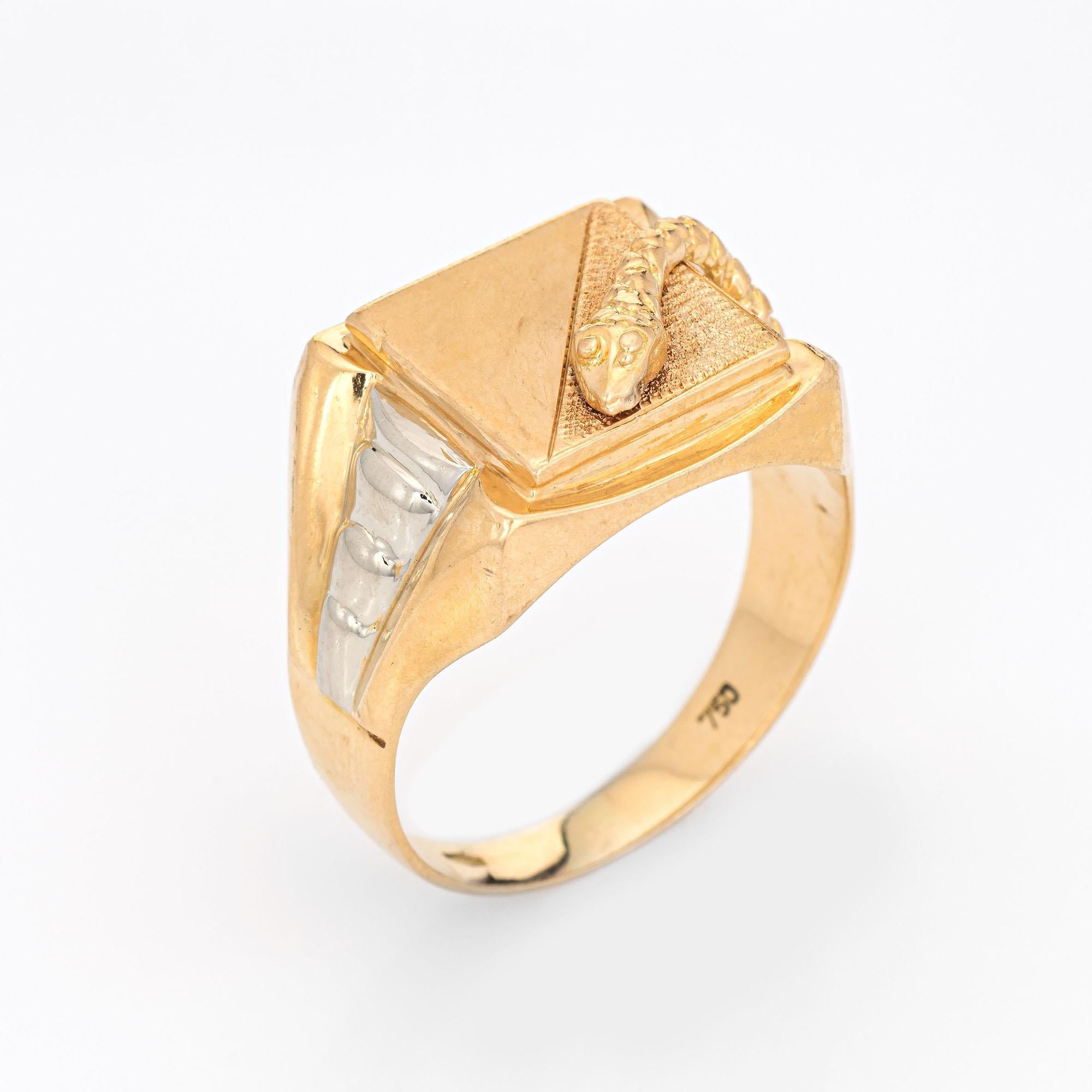 Stylish vintage snake ring (circa 1960s to 1970s) crafted in 18 karat yellow gold. 

The square signet mount features a snake meandering from the side shank onto the mount. Half of the square mount can accommodate personalization if desired.  The