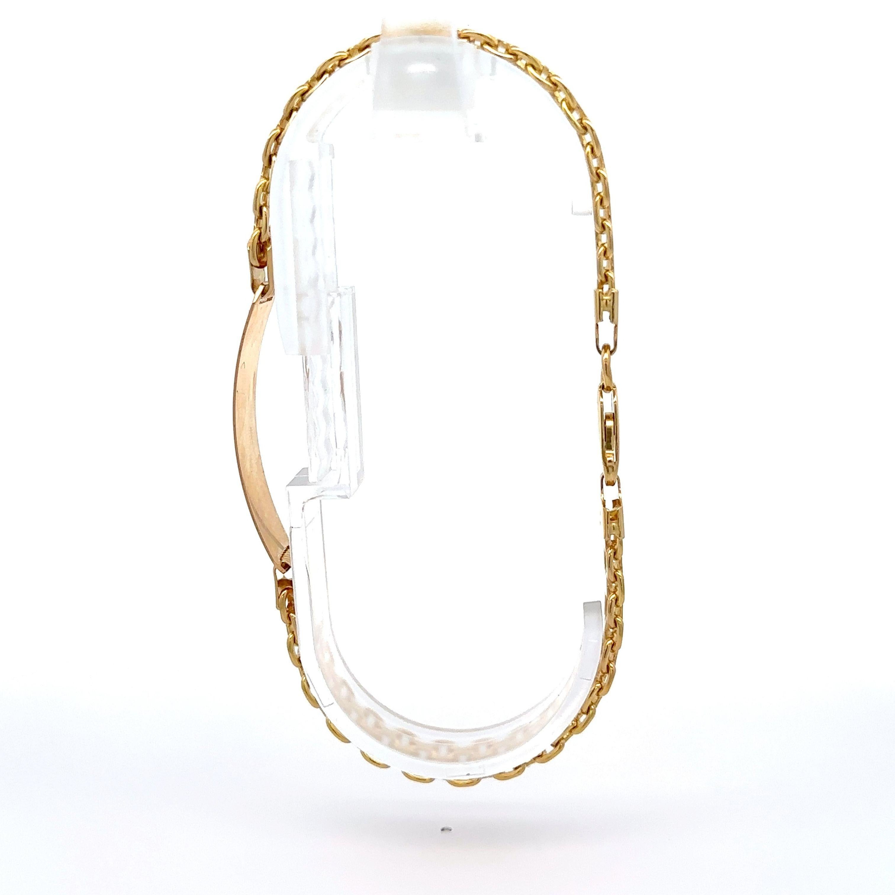 Material: Solid 18k Yellow Gold
Weight: 21.49 Grams
Length: Will comfortably fit up to a 9 inch wrist (fitted on a wrist)
Chain Type: 2.1mm Bismark Link
Clasp: Lobster Claw
Centerpiece Dimensions: 37.6x9.2mm (1.4x0.36