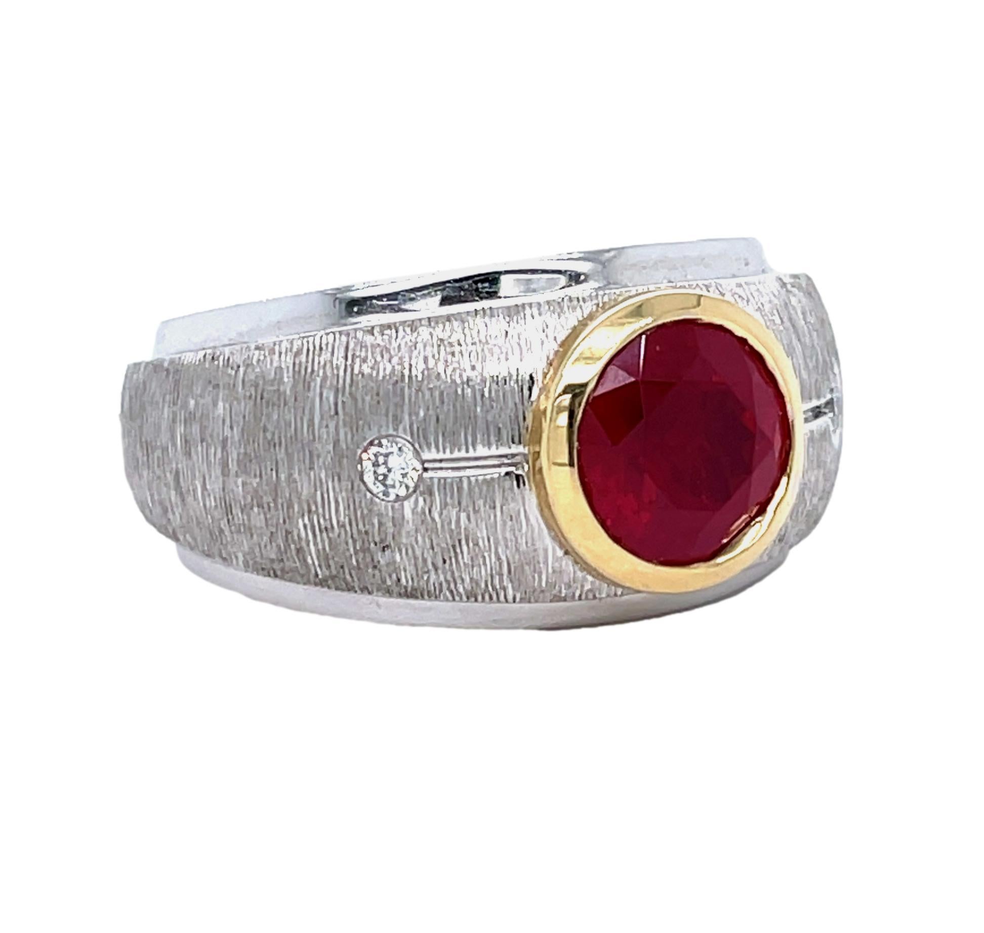This unique Men's ring has a deep red top quality round Spinel center with two brilliant cut diamonds  on the side. This ring is two tone with 14K yellow gold around the Spinel and 14K white gold band. It comes with detailed tags and shipped in a
