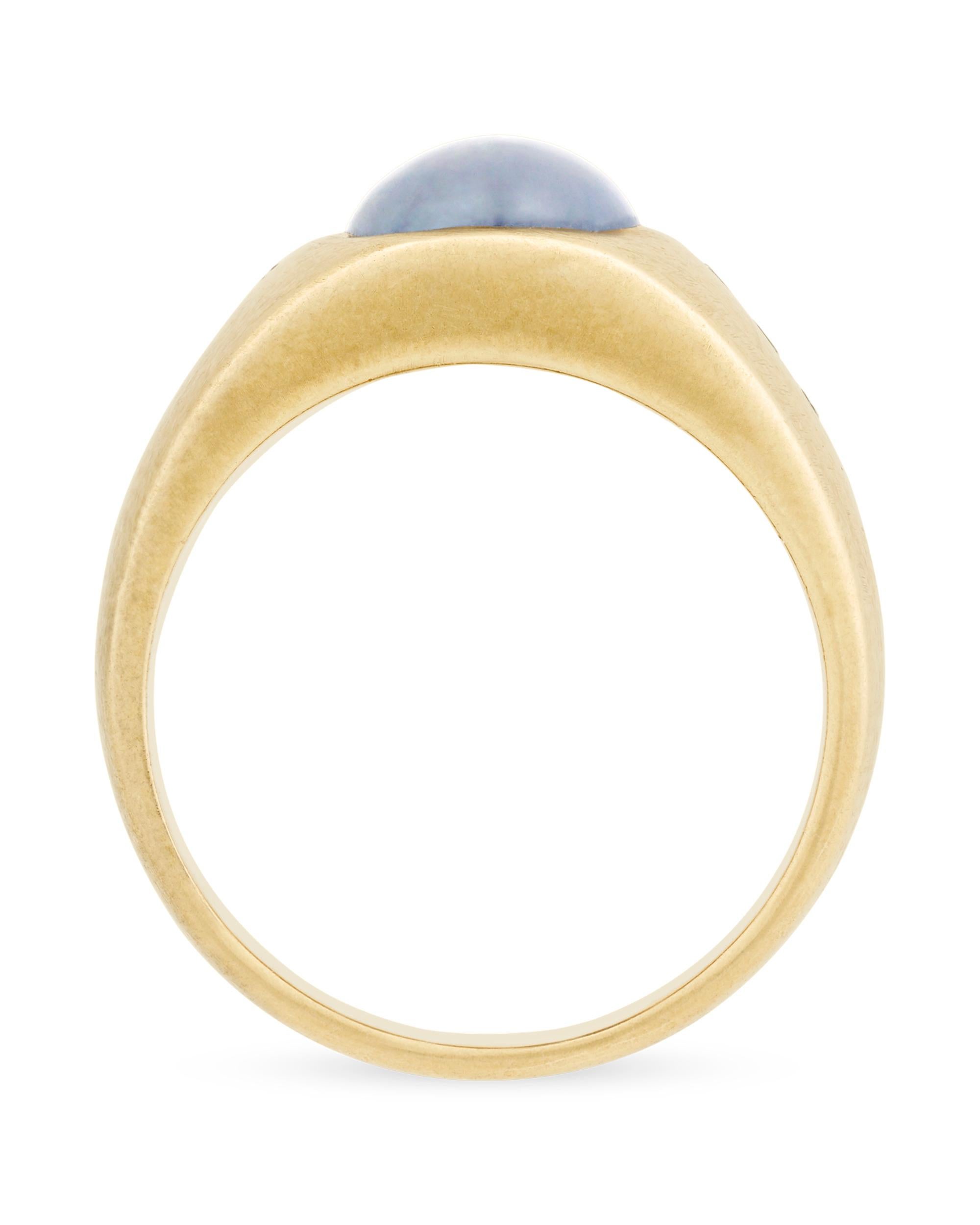 An amazing star sapphire displays its radiant star in this handsome men's ring. White diamonds provide the perfect accompanyment to this wondrous stone it its 14K yellow gold setting. The star sapphire’s trademark six-pointed star is the result of a