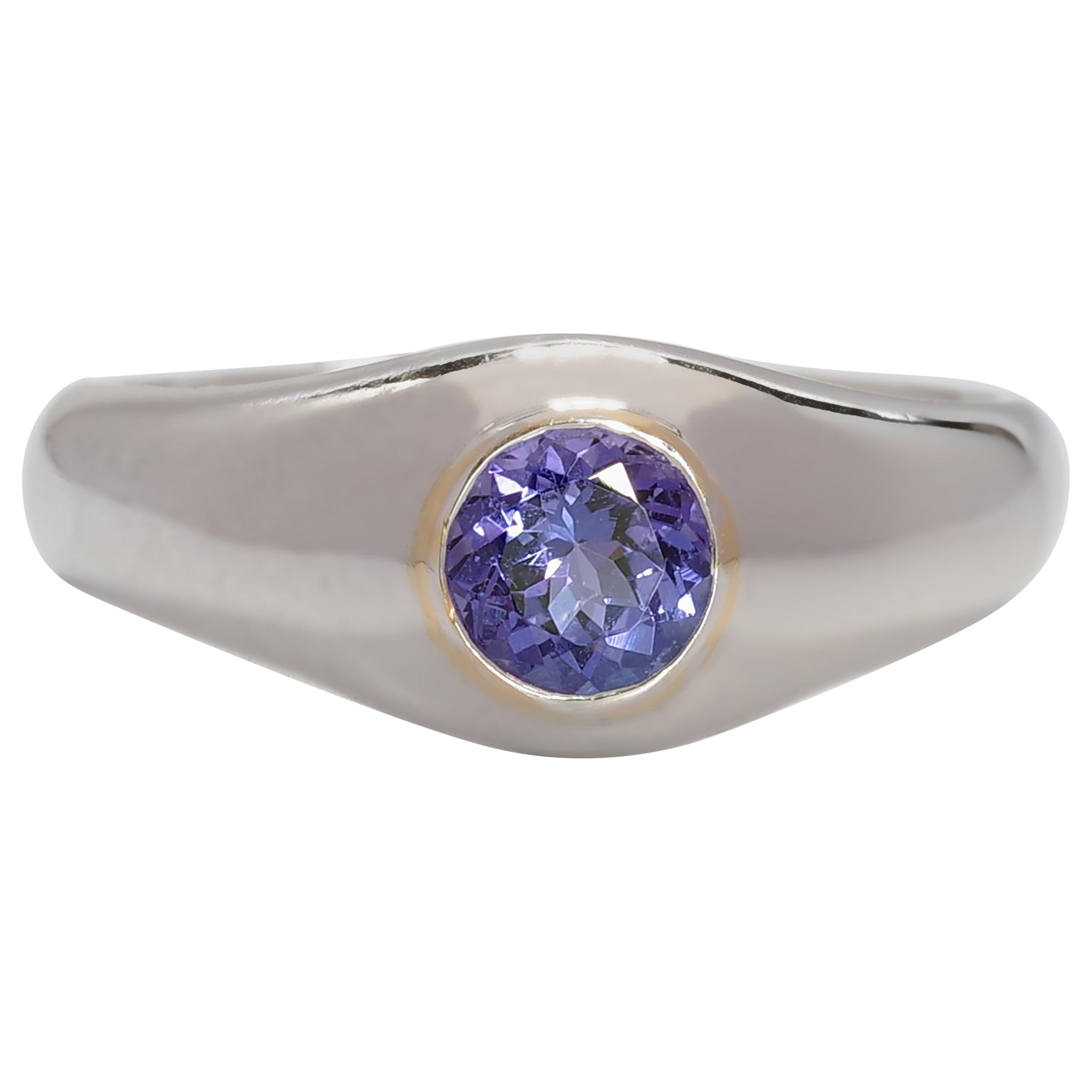 Here's the thing: Tanzanite rings for men typically feature huge stones and lots of diamonds. I felt there should be a more *discreet* men's tanzanite ring so I designed one and had it fabricated by a jeweler in Manhattan. This 14k white gold ring