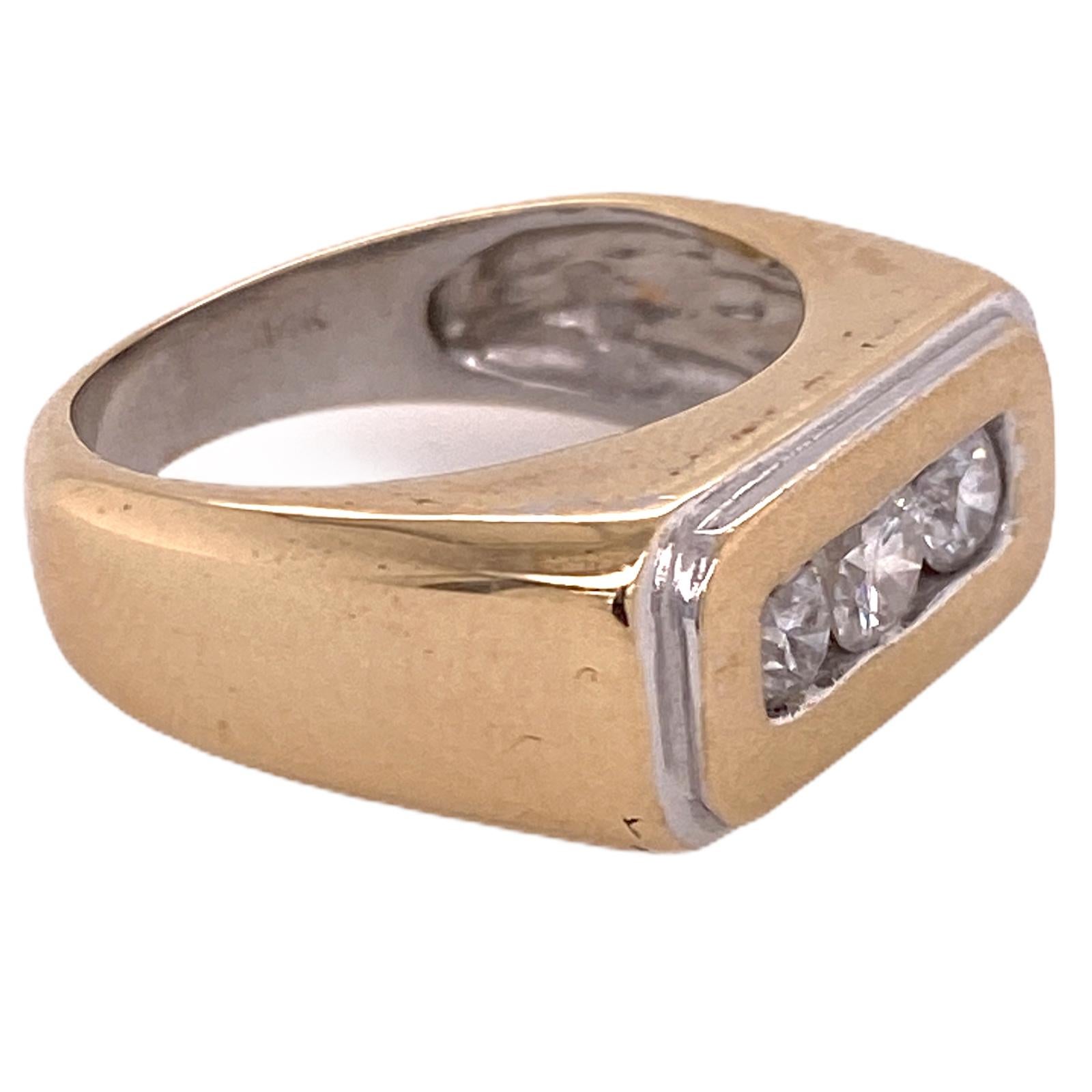 Fabulous men's 3 diamond ring fashioned in 14 karat yellow and white gold. The band features 3 round brilliant cut diamonds weighing approximately 1.00 carat total weight. The diamonds are graded H-I color and SI clarity. The ring measures 10mm