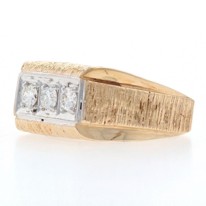 Step out in style! Fashioned in 14k yellow gold, this handsome ring showcases a trio of sparkling diamonds set in a gleaming frame of 14k white gold and highlighted by brushed detail work featured along the shoulders and bridge. 

This ring is a
