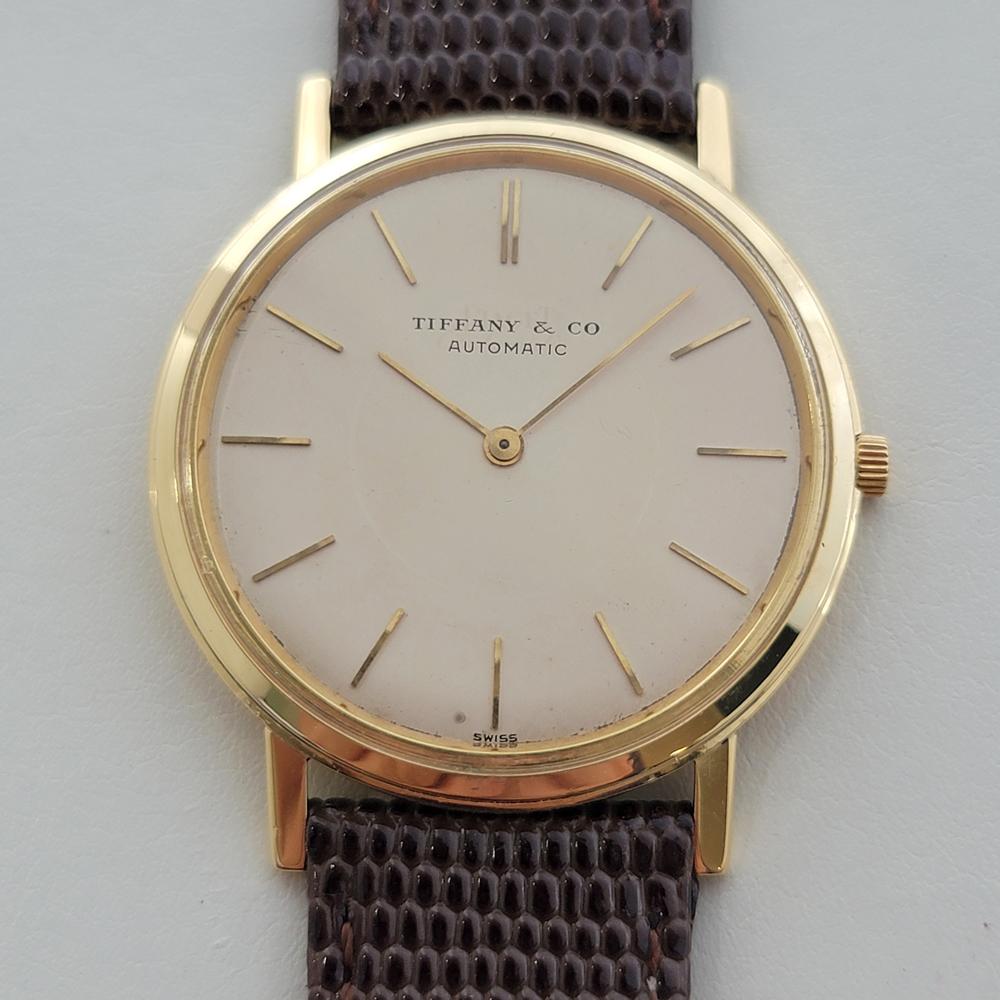  Timeless luxury, 18k solid gold Men's Tiffany & Co. Piaget ultra slim automatic dress watch, c.1960s, in excellent working condition. Verified authentic by a master watchmaker. Gorgeous, Tiffany & Co. signed dial, applied baton index hour markers,