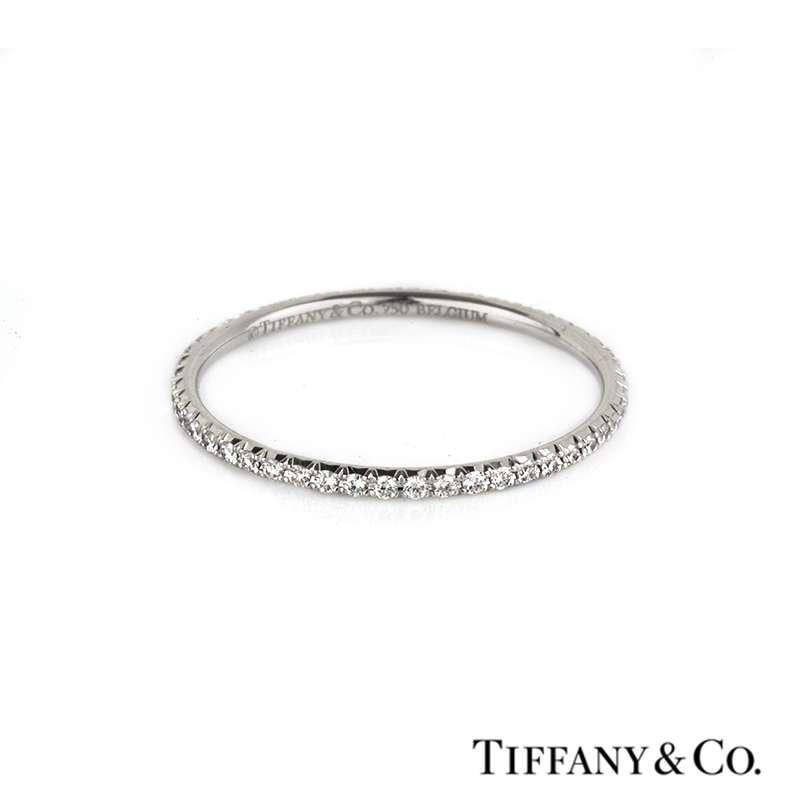 A Tiffany & Co 18k white gold Metro eternity ring. The ring is set with 49 round brilliant cut diamonds totalling 0.20ct,  the colour is predominately G-H and the clarity is  VS+. The ring is size UK T1/2/US 9.75/EU 61.5 and has a gross weight of