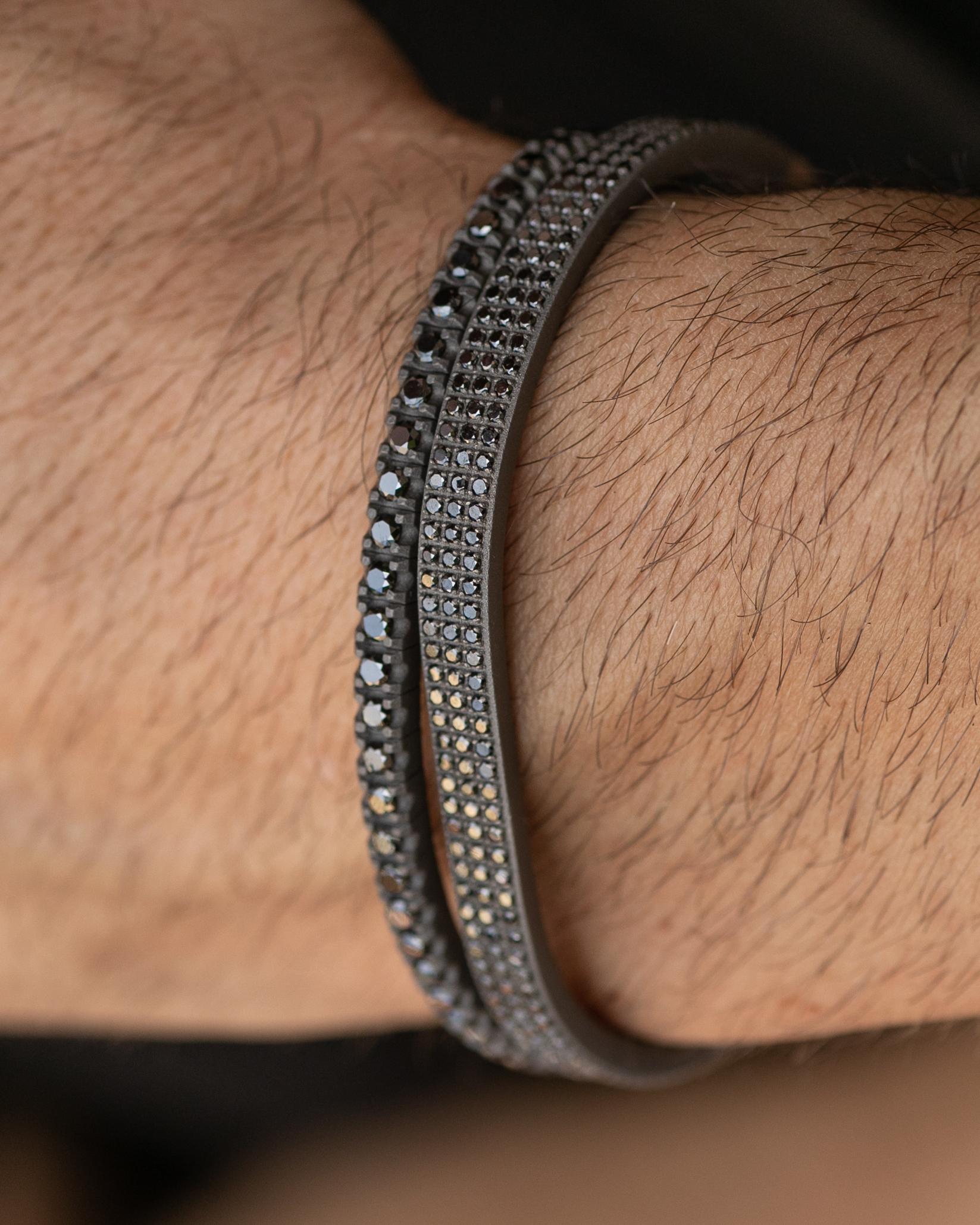 Titanium stylish bracelet is from our Men's Collection. This modern bracelet is decorated with 285 natural black round diamonds in total of 2.85 Carat placed on 18K rose gold detail. The diameter of the bracelet is 7 cm and it is 0.5cm wide. Perfect