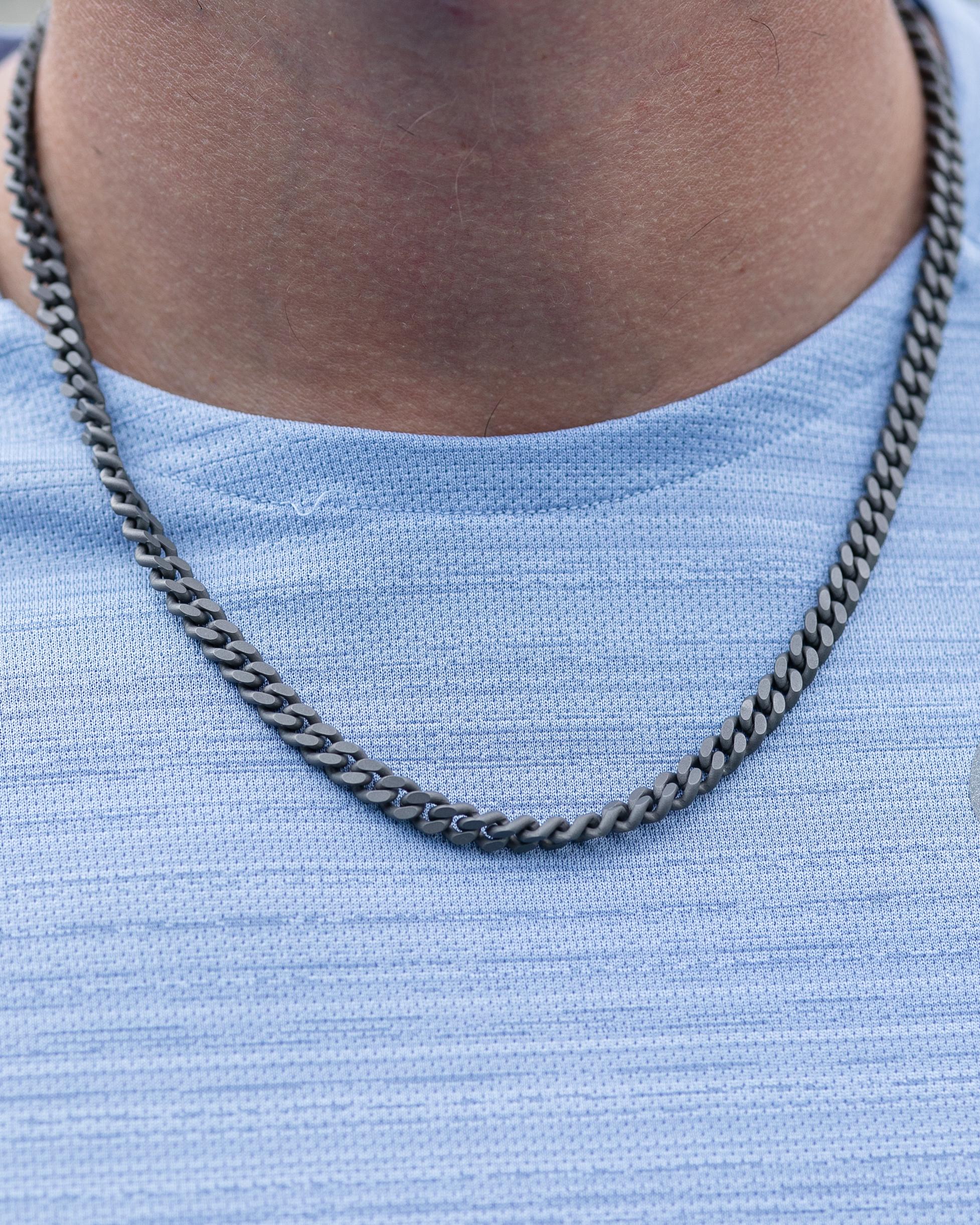 Titanium modern curb necklace is from our Heroes Collection. The necklace is made of titanium with a decorative round black diamond 0.01 Carat on the closing. The total metal weight is 0.15gr. The chain is 50cm long. Perfect for manly look!

The