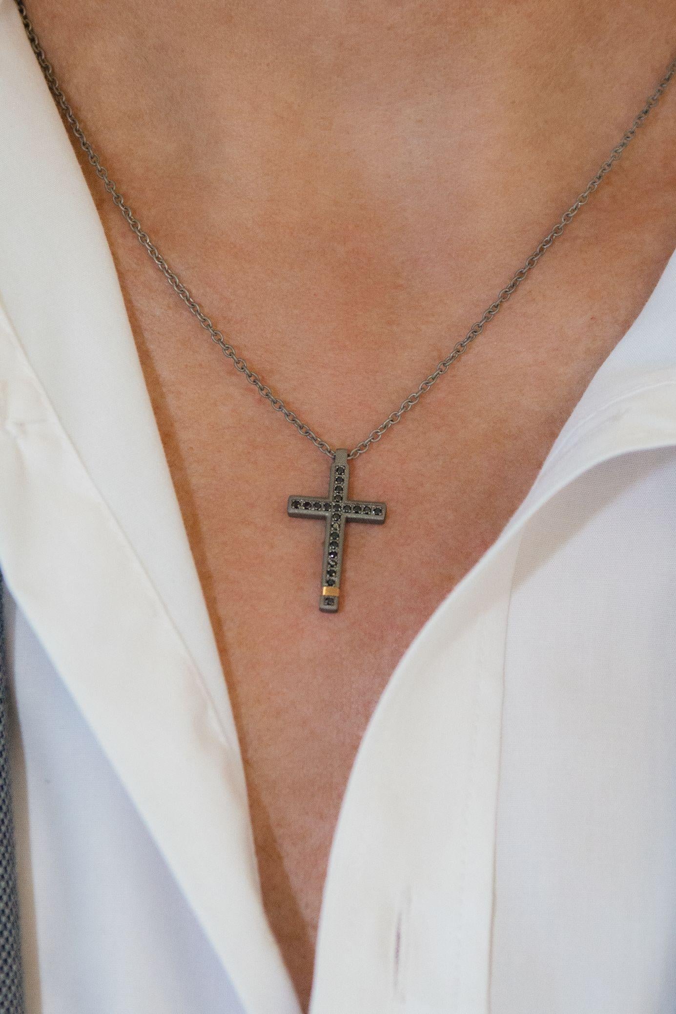 Titanium modern pendant is from our Men’s Collection. The cross pendant is decorated by 22 natural round black diamonds in total of 0.22 Carat and with a 18K rose gold detail. The size of the cross is 3cm x 1.5 cm. The chain is 54cm long. Perfect
