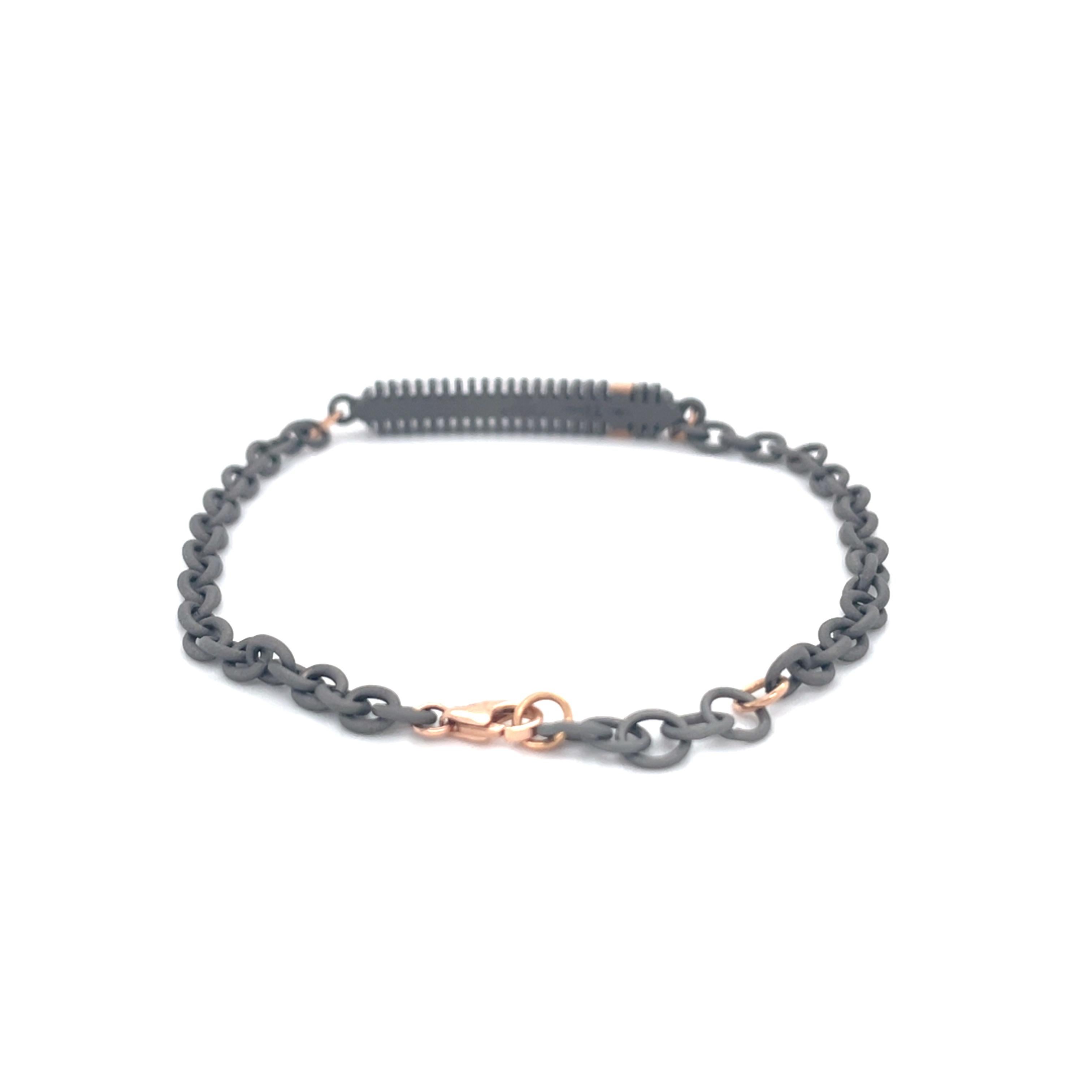 This titanium rose gold bracelet is from our Men's Collection. This modern chain bracelet is decorated with 3 natural colorless round diamonds in total of 0.03 Carat placed on 18K yellow gold detail. The bracelet is 20cm long. Perfect for daily