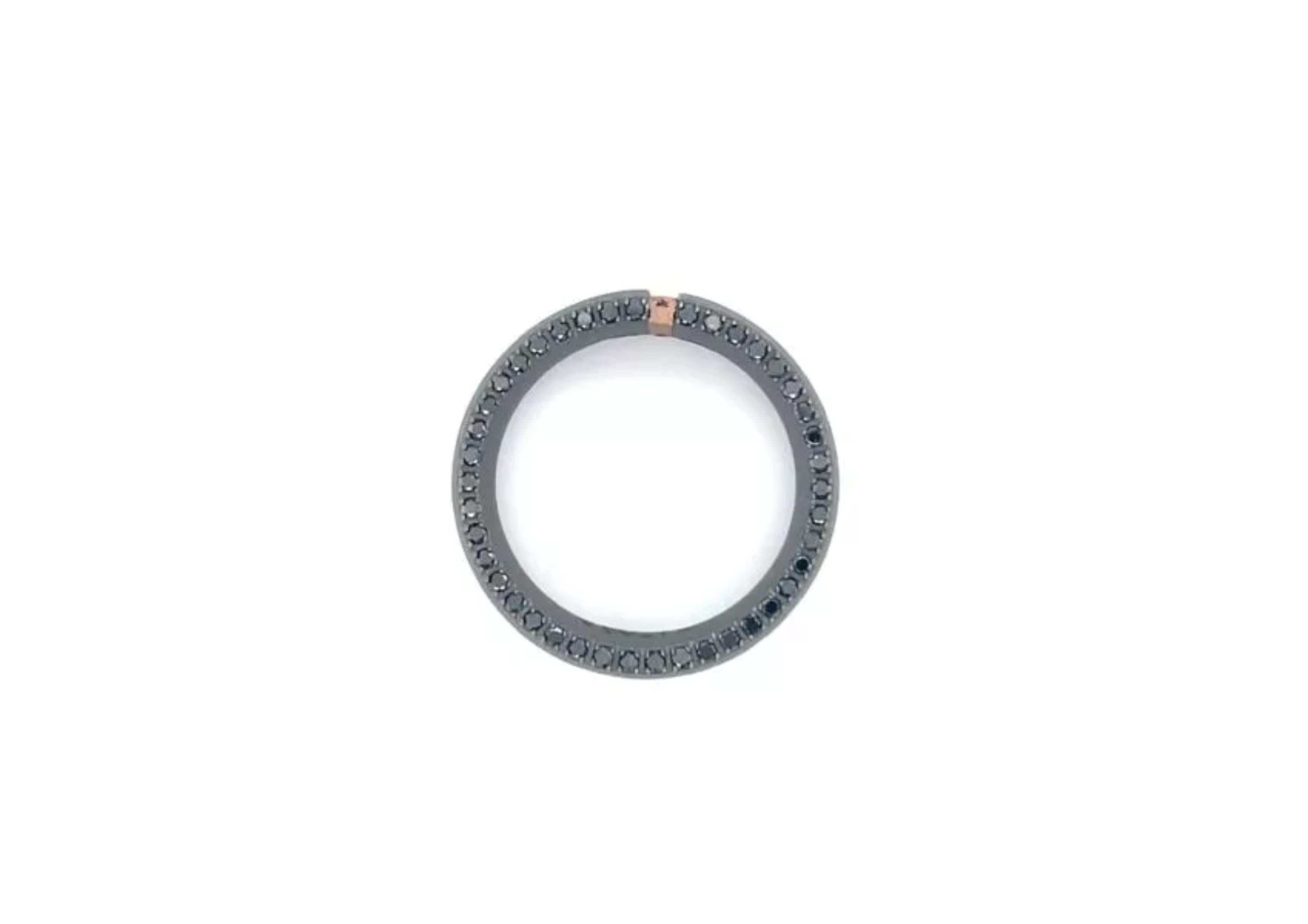 Titanium band ring is from our Men's Collection. This masculine band ring is decorated with 82 natural black diamonds in total of 0.82 Carat placed on both sides of the band with a rose gold decorative detail. The band is 0.8cm wide. Nice for a