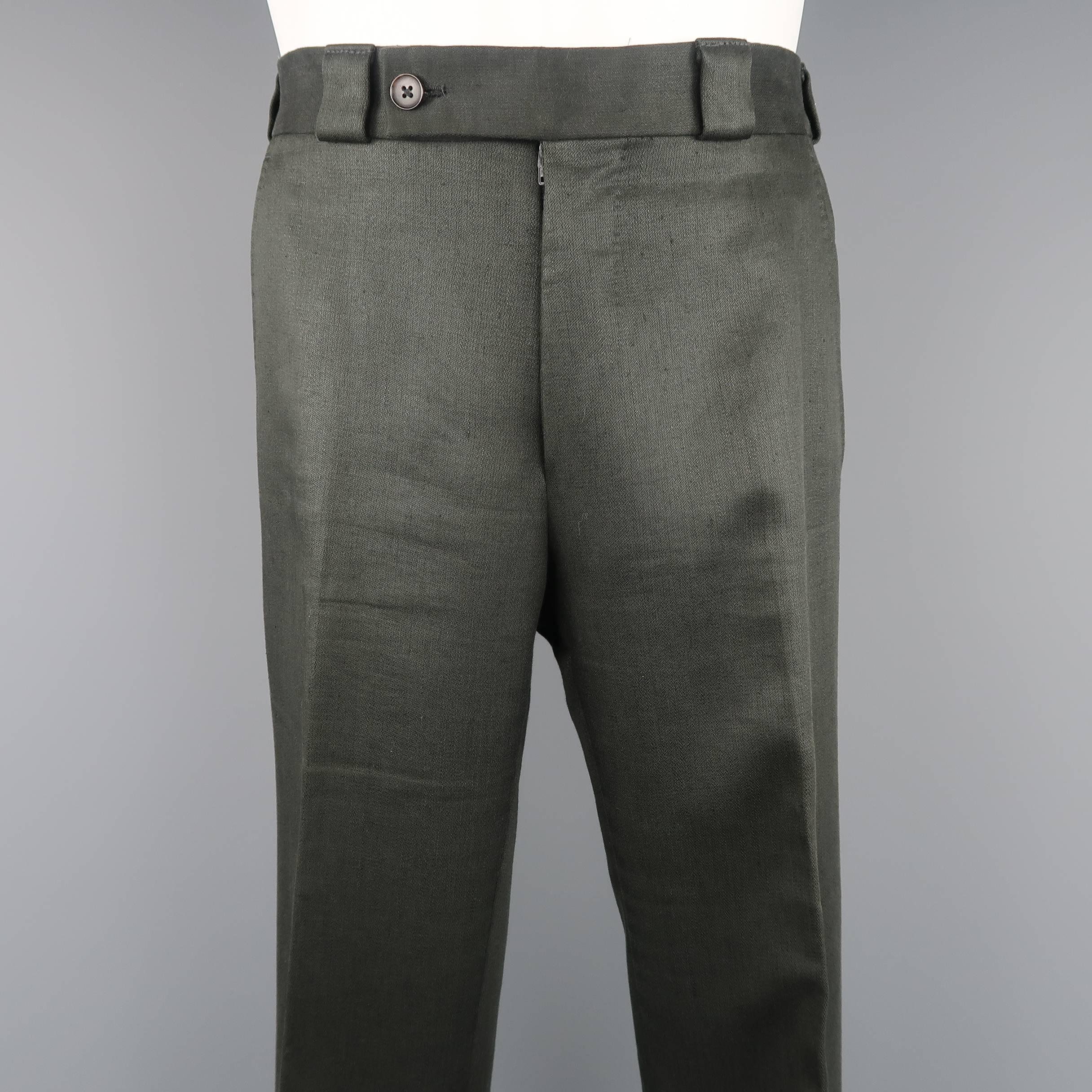 TOM FORD dress pants come in a thick linen material with a button tab waistband, zip, fly, and flat front leg. Wear throughout. Made in Italy.
 
Fair Pre-Owned Condition.
Marked: IT 46 R
 
Measurements:
 
Waist: 32 in. (+2 in.)
Rise: 10 in.
Inseam: