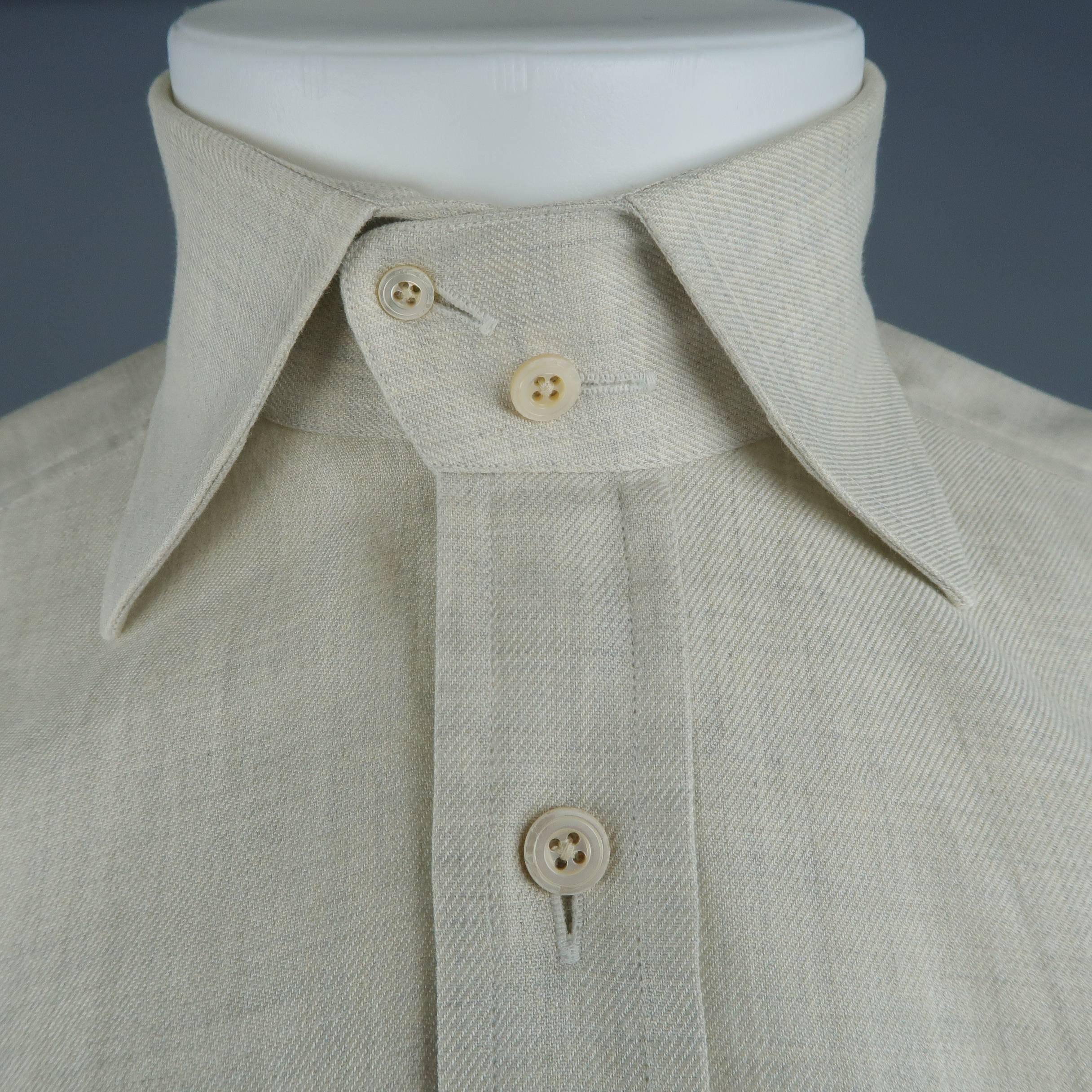 TOM FORD dress shirt comes in a textured beige cotton with a spread two button over collar, double breast pockets, and two button cuffs. Broken button. As-is. Made in Italy.
 
Good  Pre-Owned Condition.
Marked: 39/15.5
 
Measurements:
 
Shoulder: 17