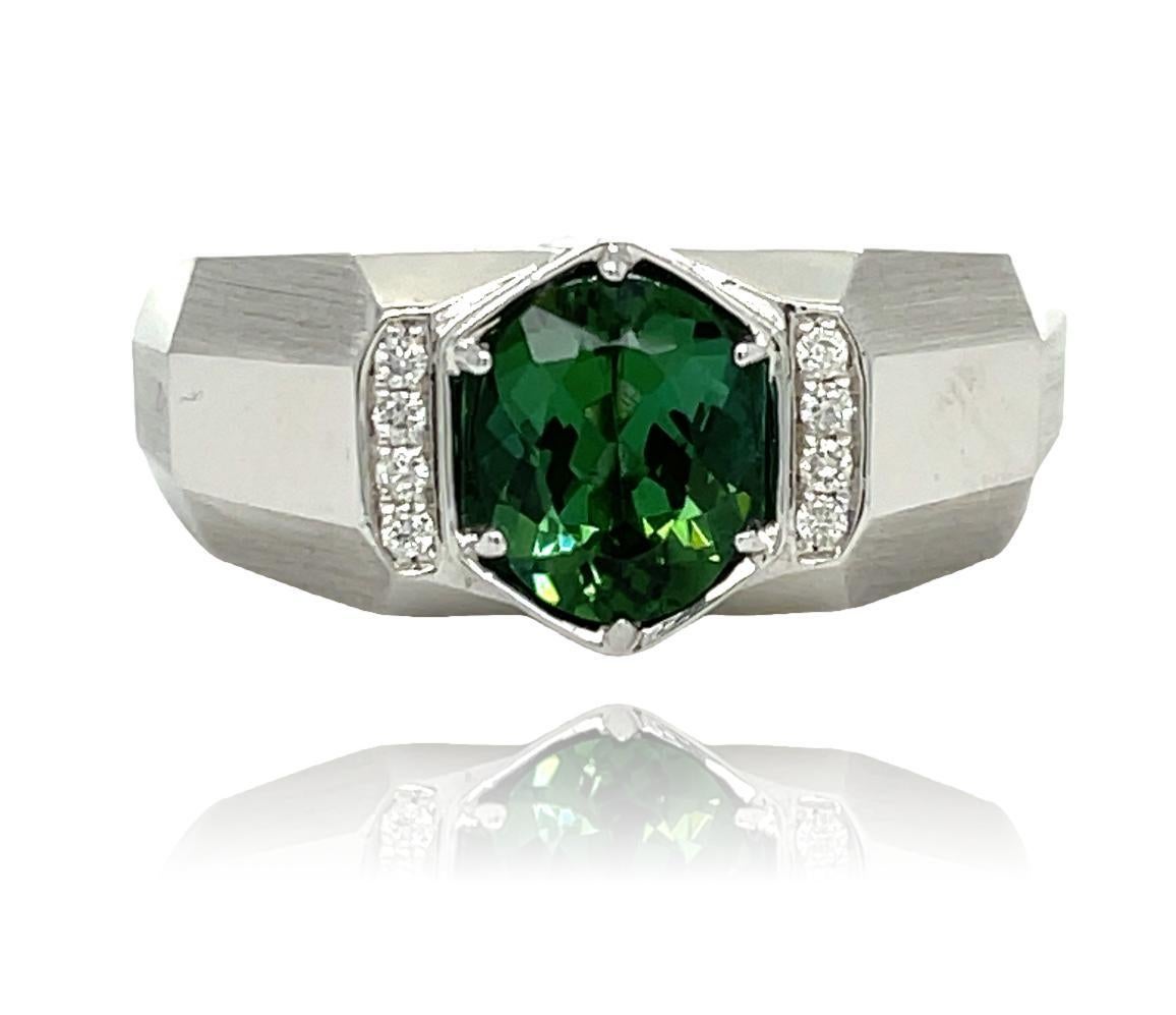 This stunning Men's ring has a natural oval Green Tourmaline center with sparkling brilliant cut diamonds on the side. The ring is set in 14K white gold. It comes in a beautiful box ready for the perfect gift!

14KW:              10.85