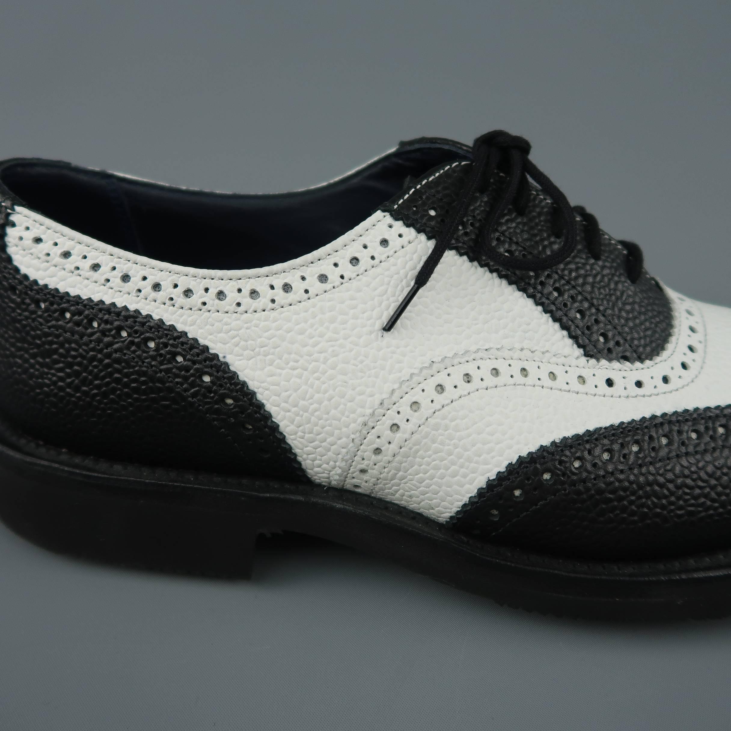 JUNYA WATANABE X TRICKER'S dress shoes come in black and white pebbled textured leather with a wing tip toe, perforated brogue details throughout, and light weight rubber sole. With box. Made in England.
 
New in Box.
Marked: UK 9
 
Outsole: 12.25 x