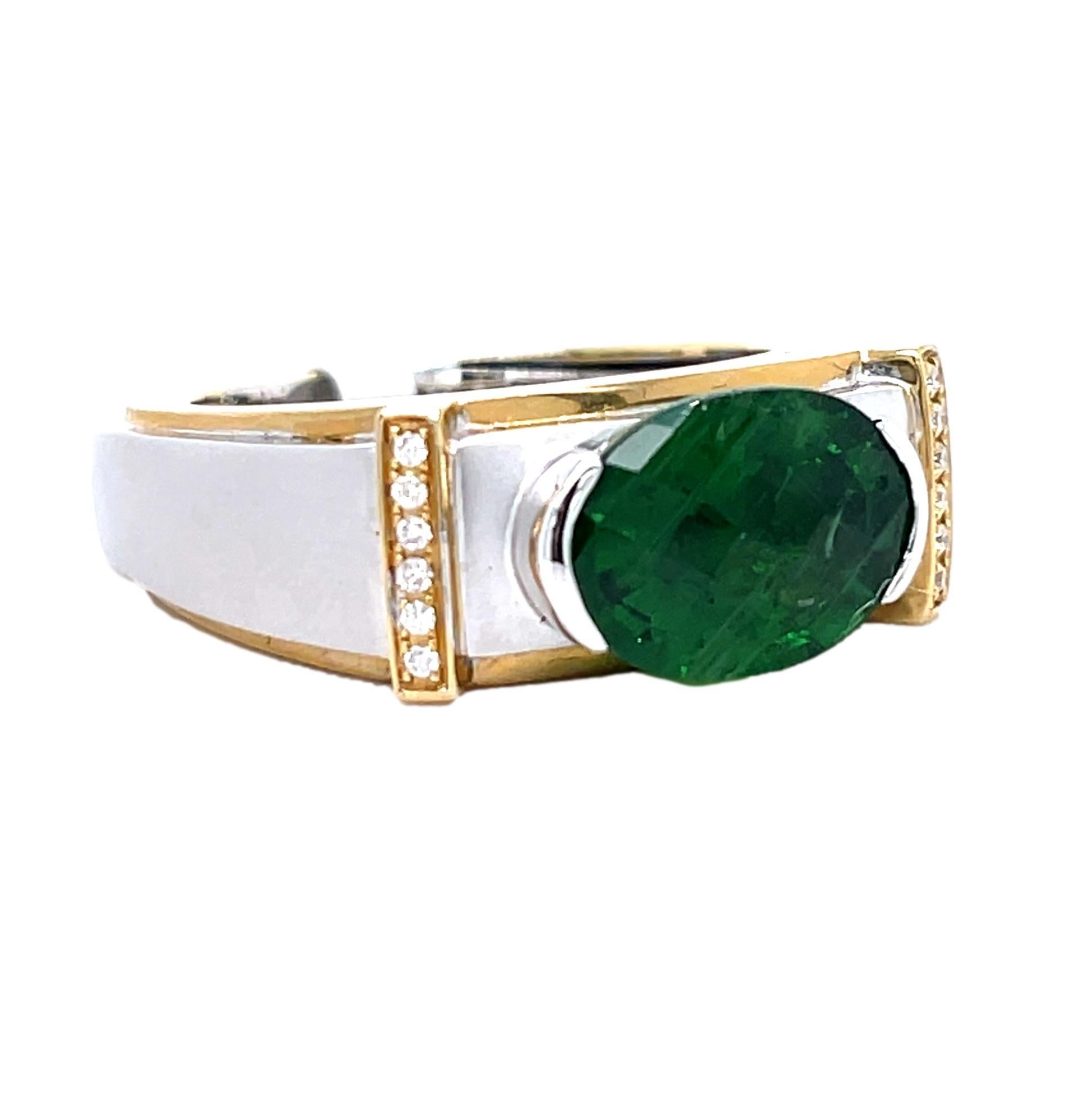 This unique Two Tone Men's ring has a sparkling checkerboard oval Tsavorite center with brilliant cut diamonds on the side. The ring is set in 18K white and yellow gold. It comes in a beautiful box ready for the perfect gift!

18KWY:           