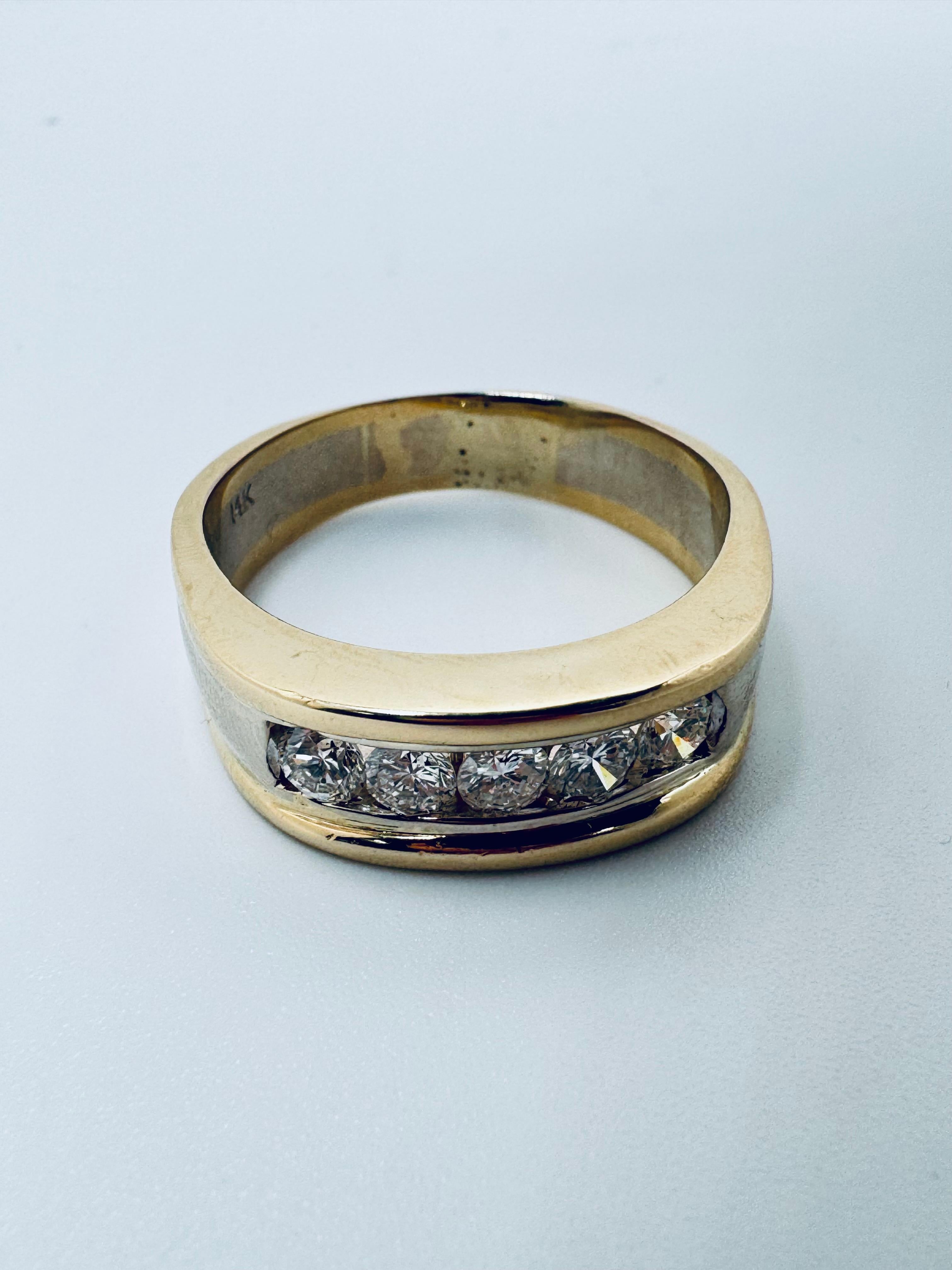 This Men’s Two-Toned Channel Set Diamond Wedding Band is a bold and refined statement piece crafted in a combination of 14K yellow and white gold. The substantial gold weight of 13.25 grams highlights its durability and masculine presence, making it
