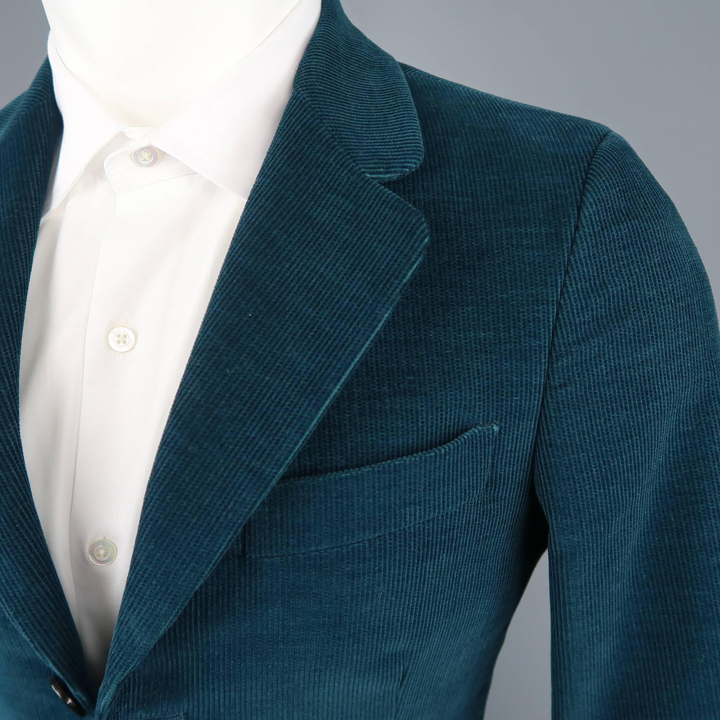 UMIT BENAN sport coat comes in dark teal green textured corduroy with a notch lapel, three button closure, and functional button cuffs. Made in Italy.
 
Good Pre-Owned Condition.
Marked: IT 44
 
Measurements:
 
Shoulder: 16 in.
Chest: 39 in.
Sleeve: