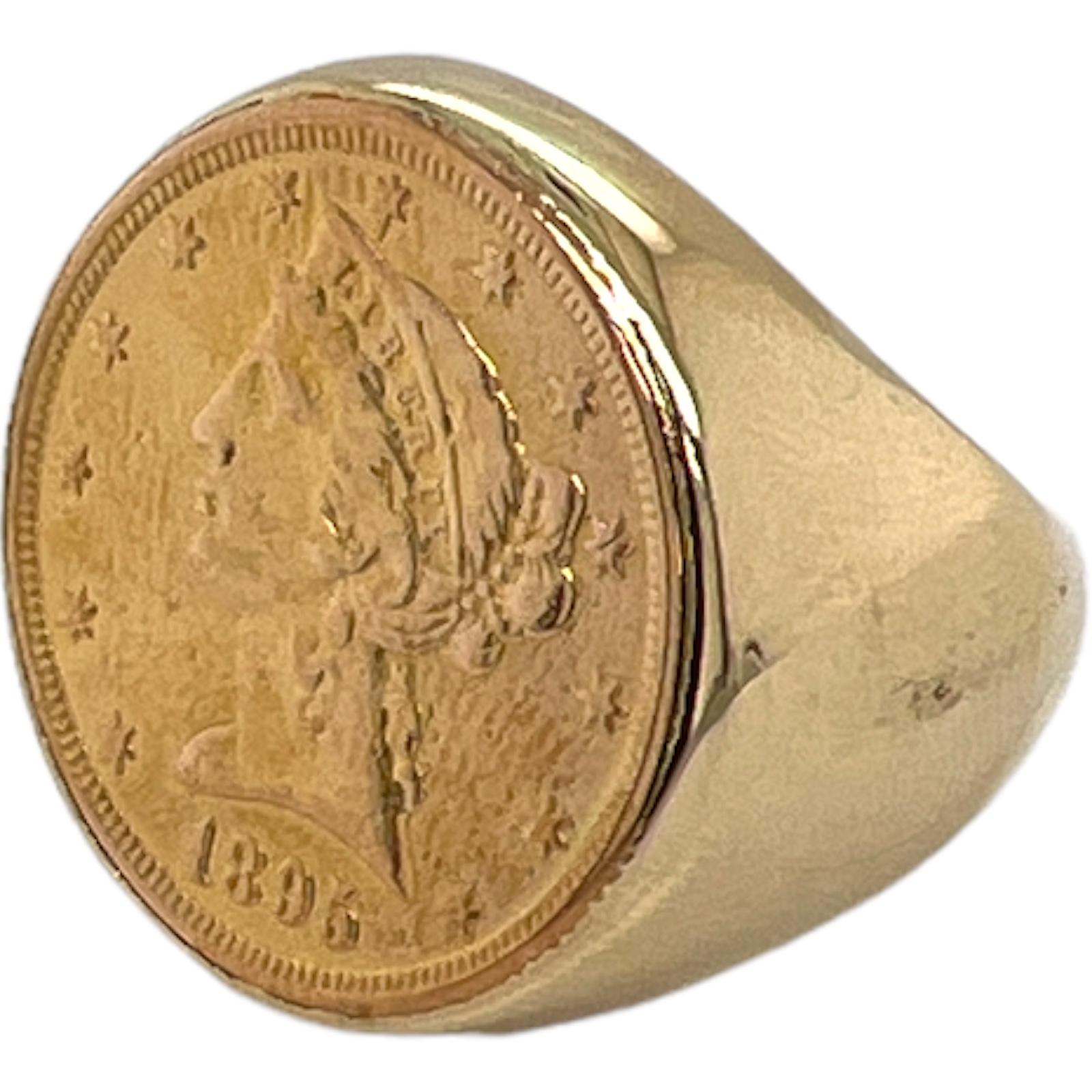 Men's gold coin ring crafted in 14 karat yellow gold. The $5 dollar US gold coin, which is 90% gold, is set in a signet style 14 karat yellow gold mounting. The ring is currently size 8.5 (can be sized), and measures 24mm in width. 
