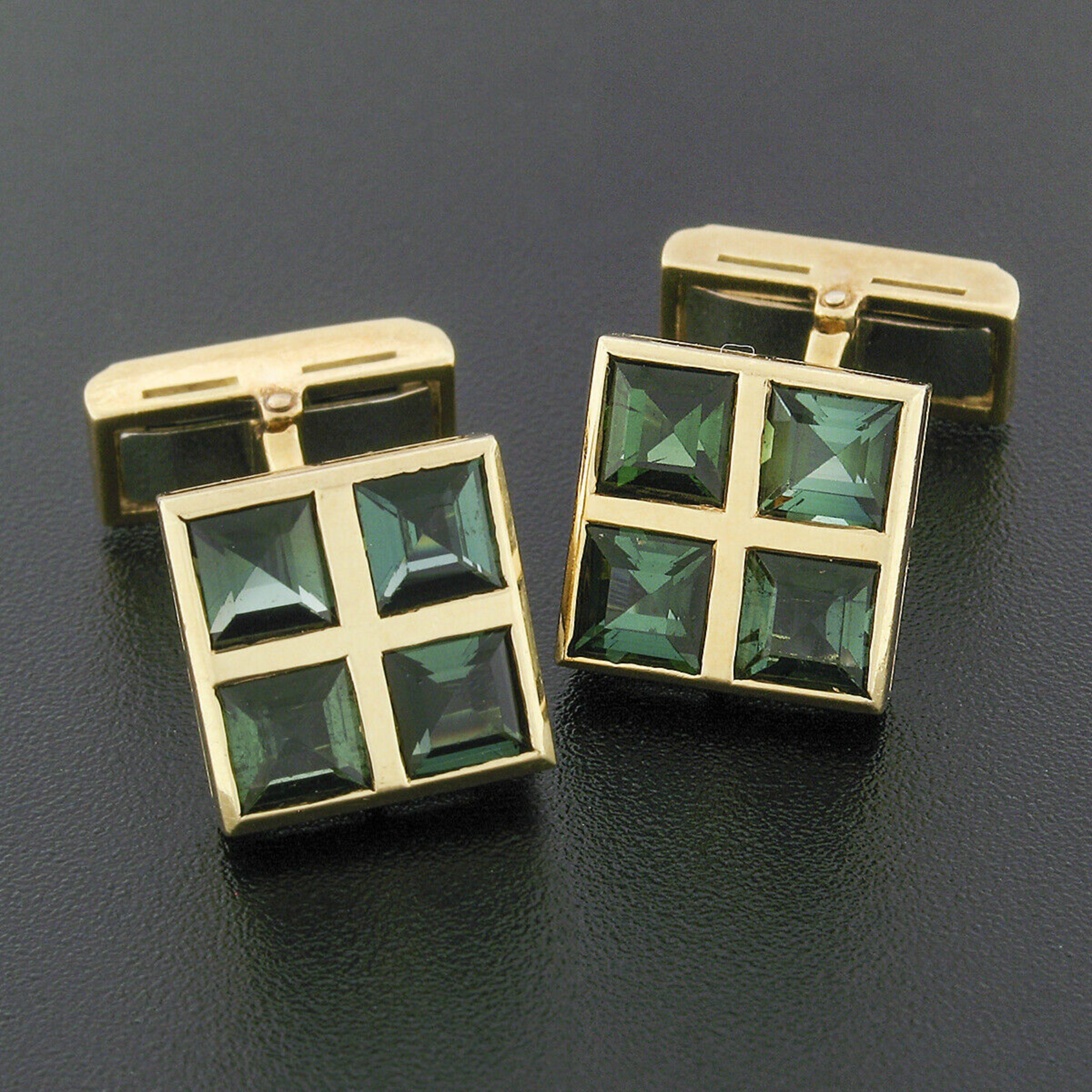 This vintage pair of men's cuff links is crafted in solid 18k yellow gold and feature a grid design that each carry four square step cut tourmalines at the front as well as two on the backing. The stones show a gorgeous, rich, vivid green color