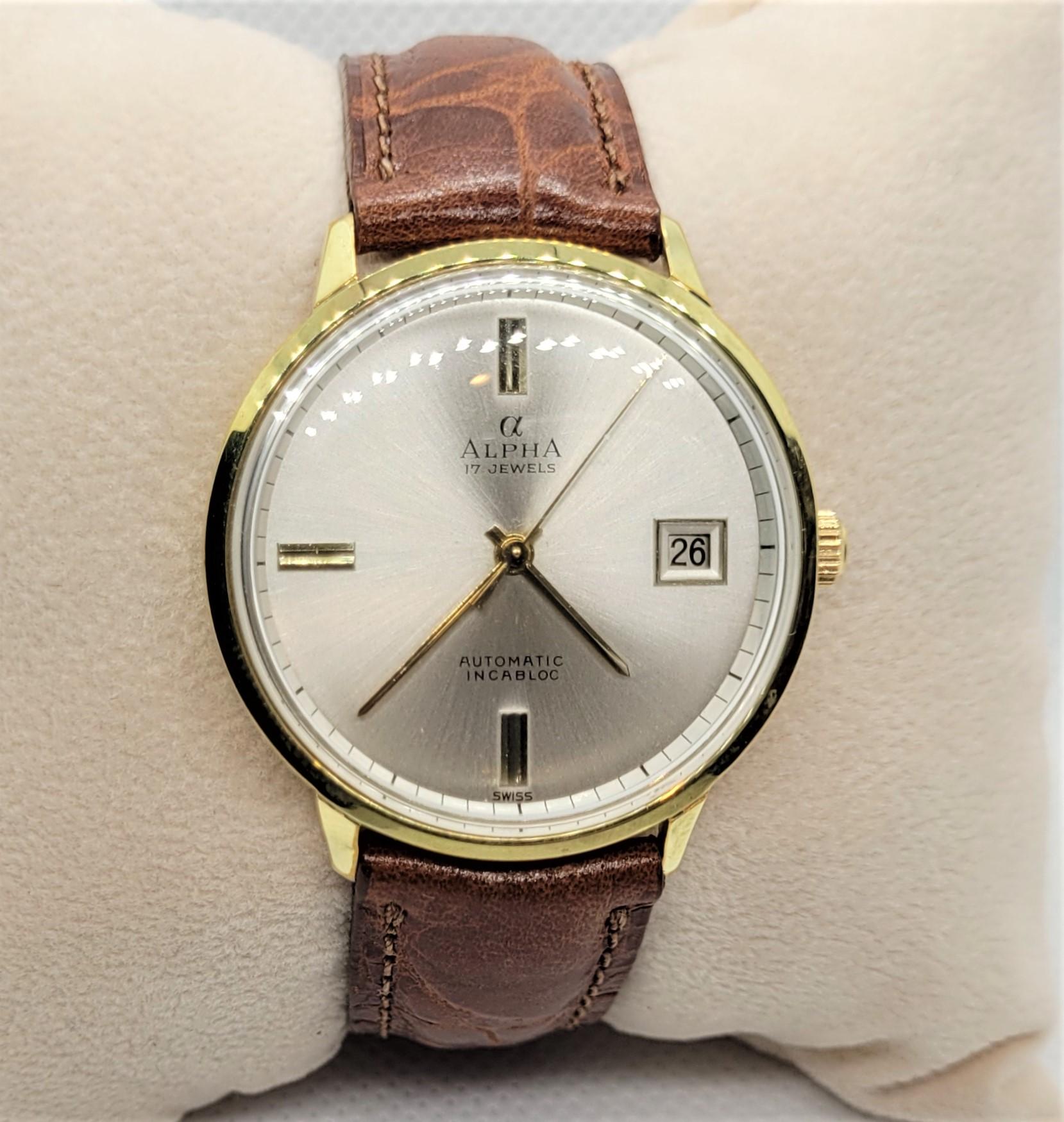 Gorgeous Men's Alpha Watch has a 17 jewel movement and is automatic. This had just been fully cleaned and overhauled and comes with a 90-day warranty. The watch is in very good working condition.  The case is 35mm diameter, gold plated, with a