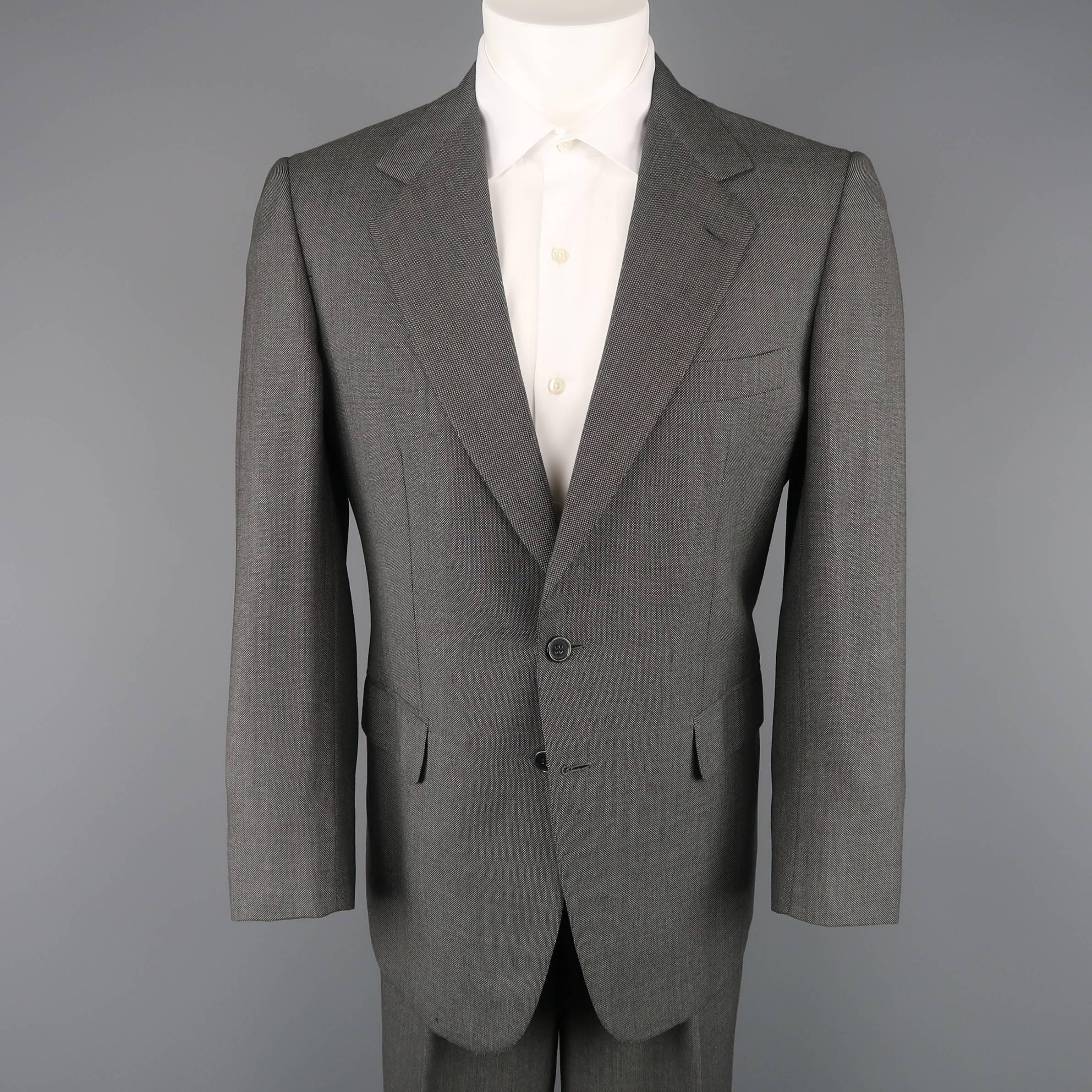 Vintage two piece BRIONI suit comes in charcoal gray nailhead print wool and includes a two button, single breasted sport coat with notch lapel and pleated trousers with cuffed hem. Discoloration on jacket shown in detail shot and internal wear on