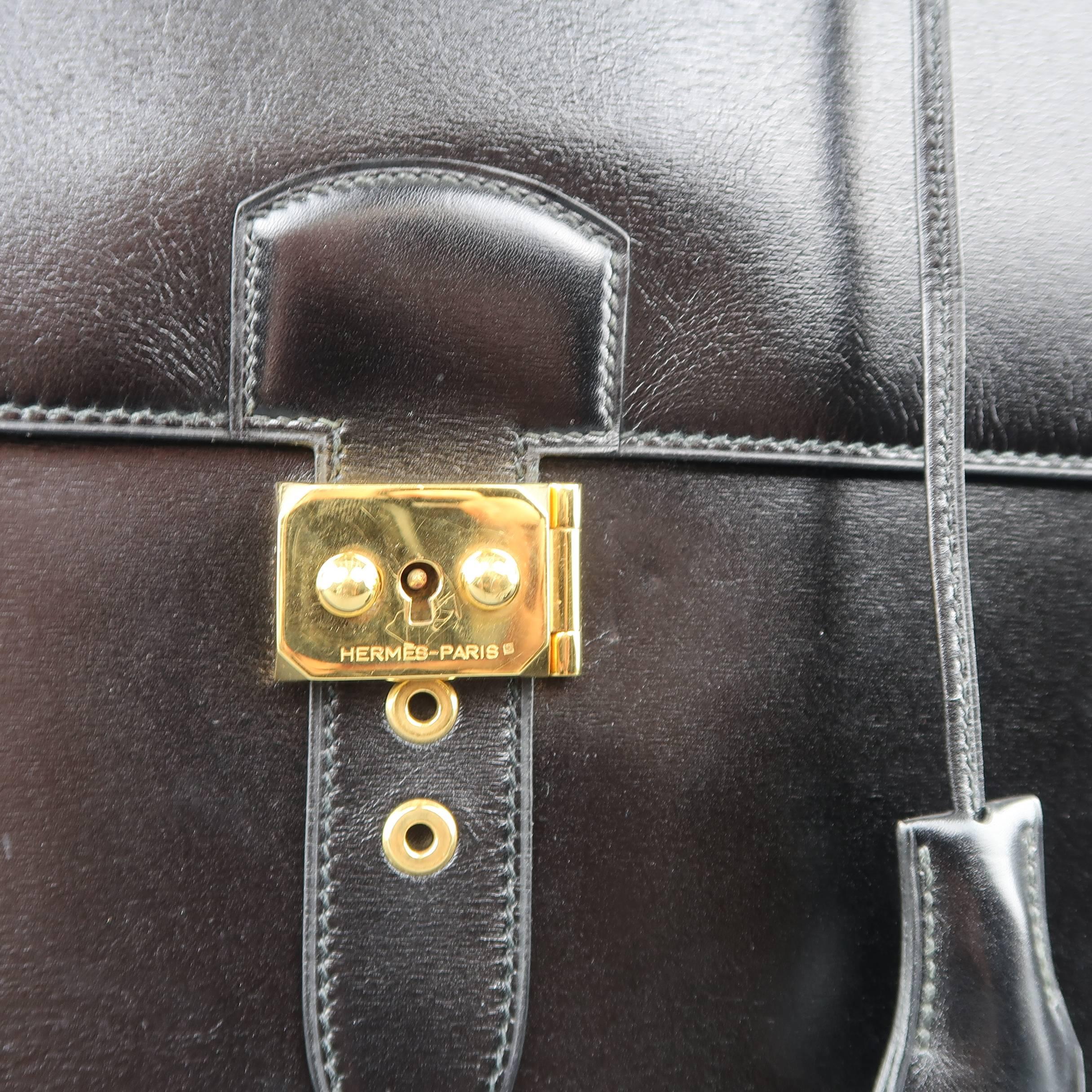 Vintage HERMES Sac a Depeches 41 briefcase comes in black leather with a top flap, gold tone embossed metal lock closure, leather top handle, clochette, and multiple storage sections. Minor wear. Made in France. Blind stamped circle T from 1990.

