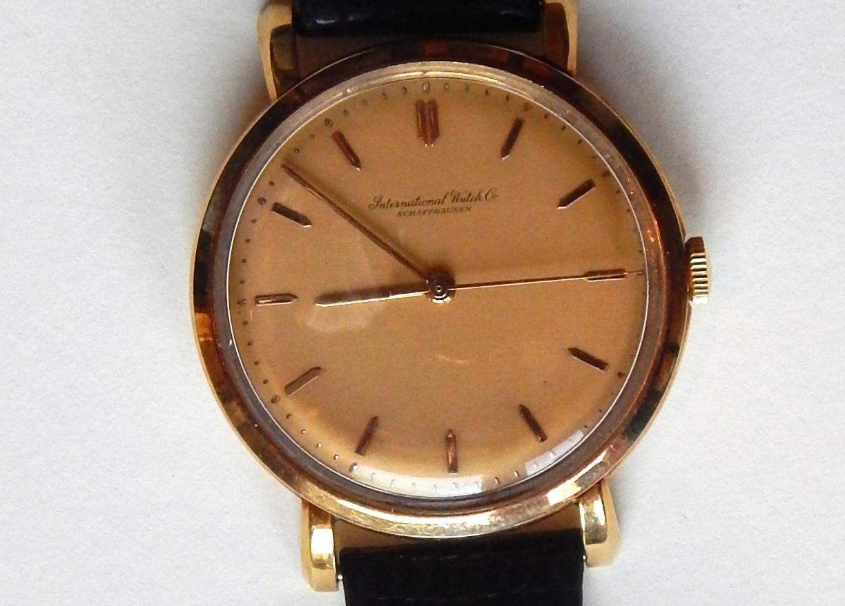 Schaffhausen vintage International Watch Co. (IWC), circa 1950s.
18-karat yellow gold watch with rose gold dial and applied yellow gold bar markers.
Swiss. Keeps accurate time.

Type: Men’s vintage watch
Case: Very good case original
Case